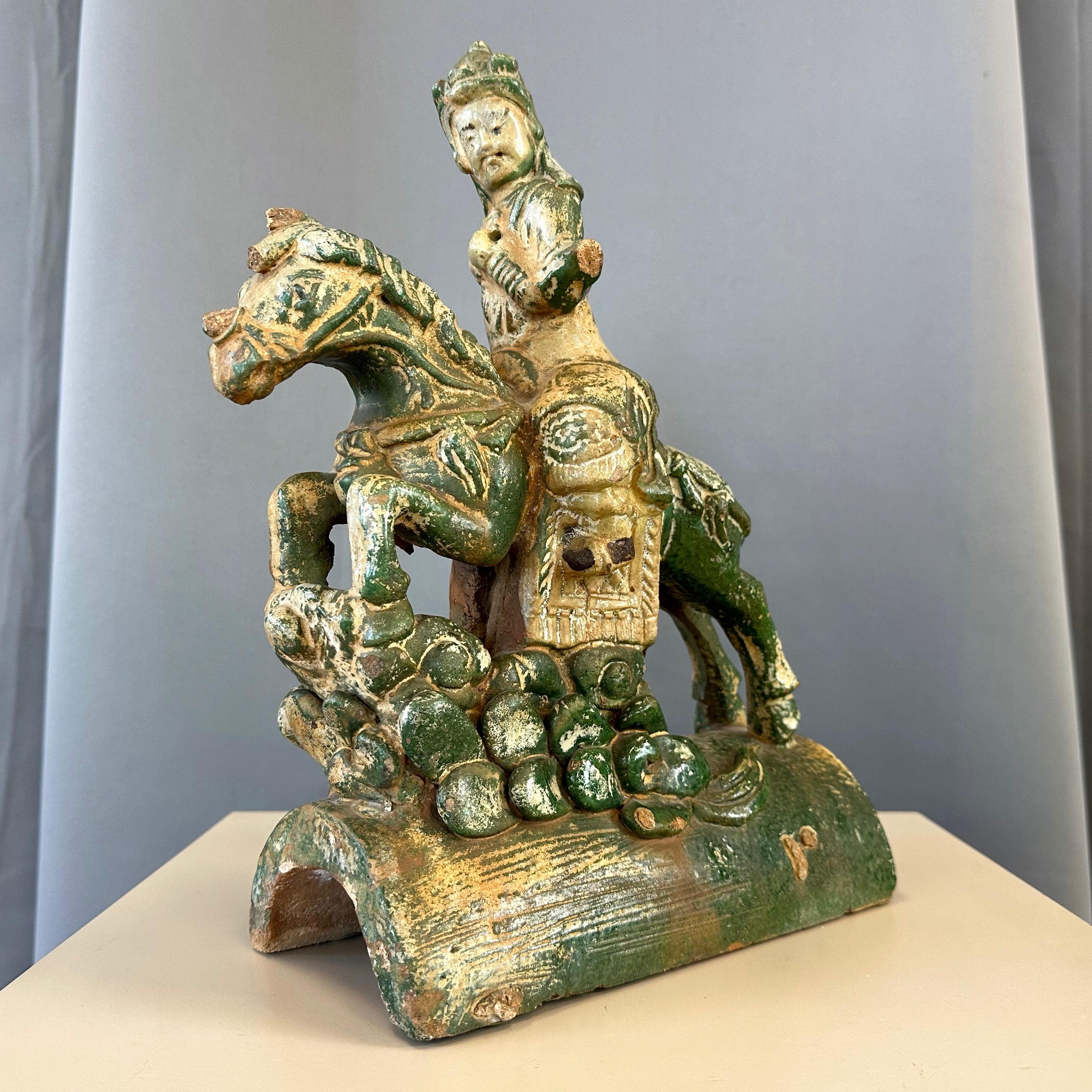 A circa 18th century Chinese Ming dynasty-style equestrian form glazed pottery roof tile.

Classic figural depiction of a proud celestial warrior on horseback, hand-crafted of earthenware or terracotta and finished in a sancai-style glaze with