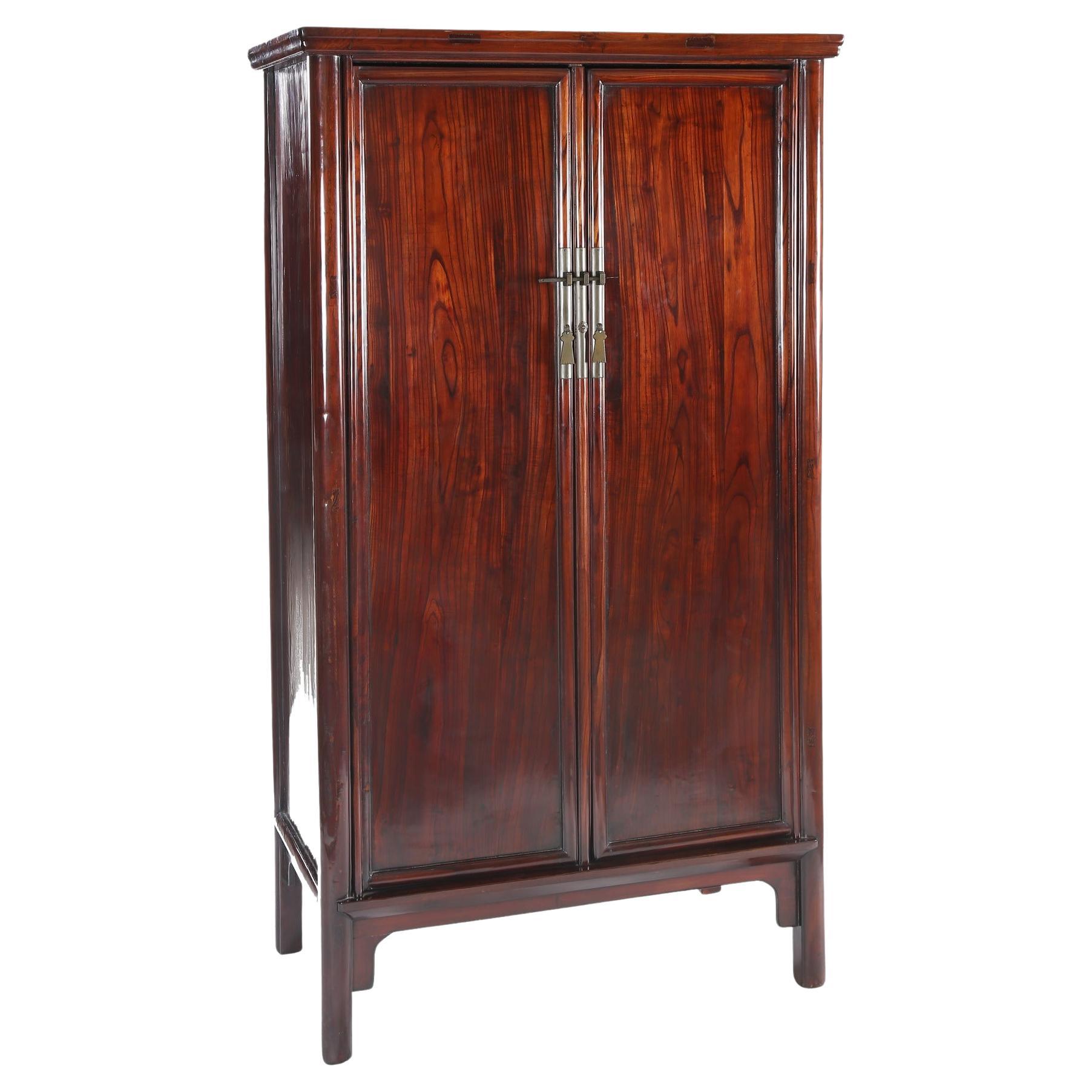 FINE TAPERED ROUND CORNER CABINET

The cabinet with protruding molded edge, supported by rounded side posts, a pair of paneled doors with central stile, opening to reveal three shelves with the mid-shelf forming the top of two drawers, the side