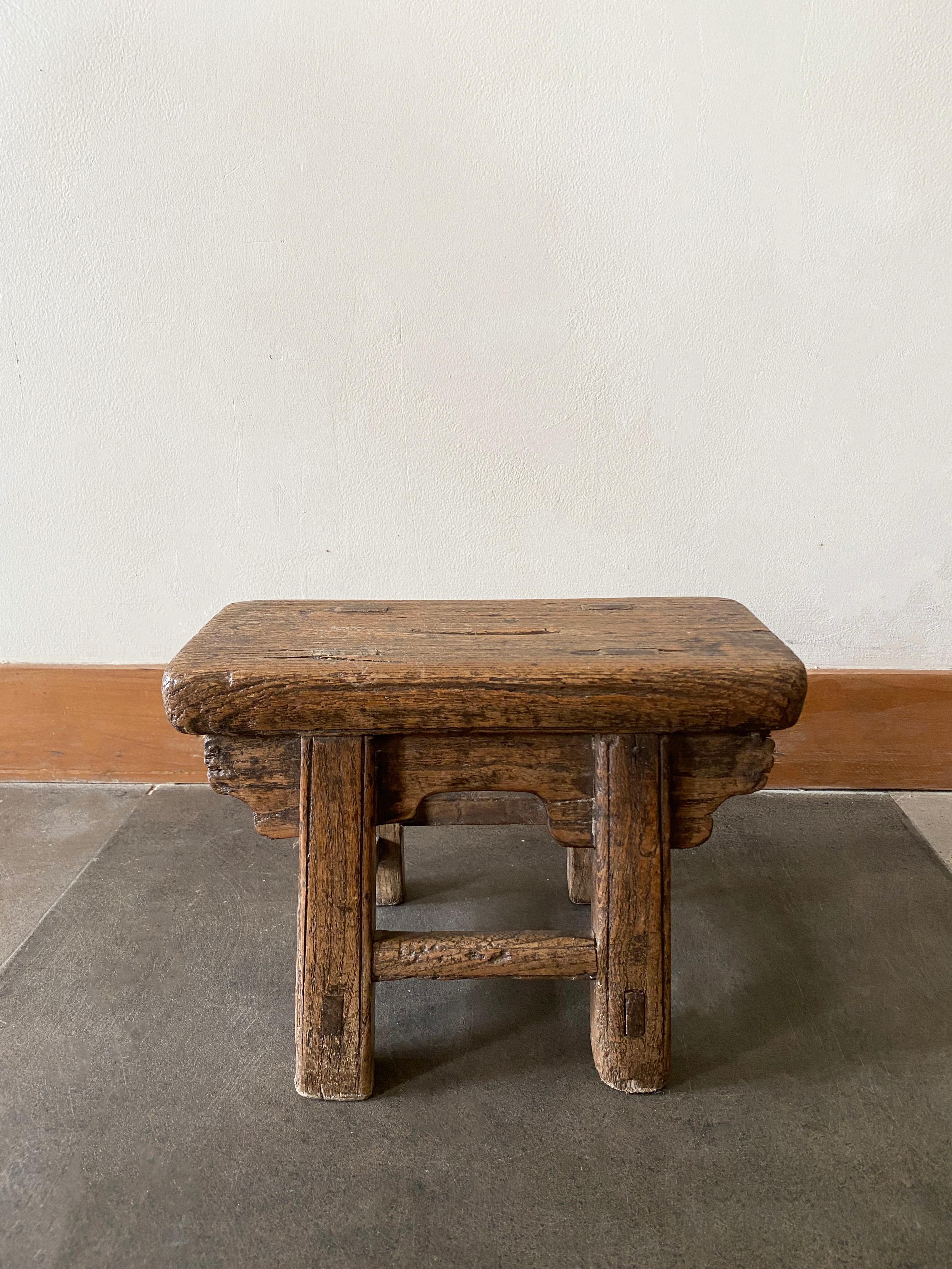 This antique mini stool features a beautiful age related patina and lacquered finish. It remains sturdy and robust, a fantastic piece to use as a drink table, table stool or for displaying small items. It dates to the early 20th century / Qing