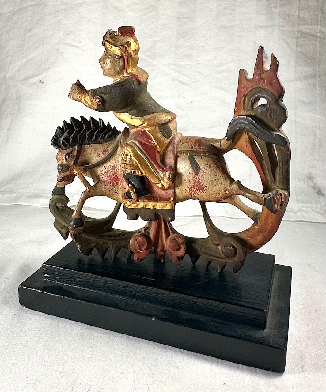 Antique Chinese Miniature Polychromed Wood Carved Statue on Stand

Beautiful polychrome painted wood hand carving features a man on horseback. It probably represents a famous Chinese figure known as NEZHA. In Chinese folklore and mythology, Nezha is