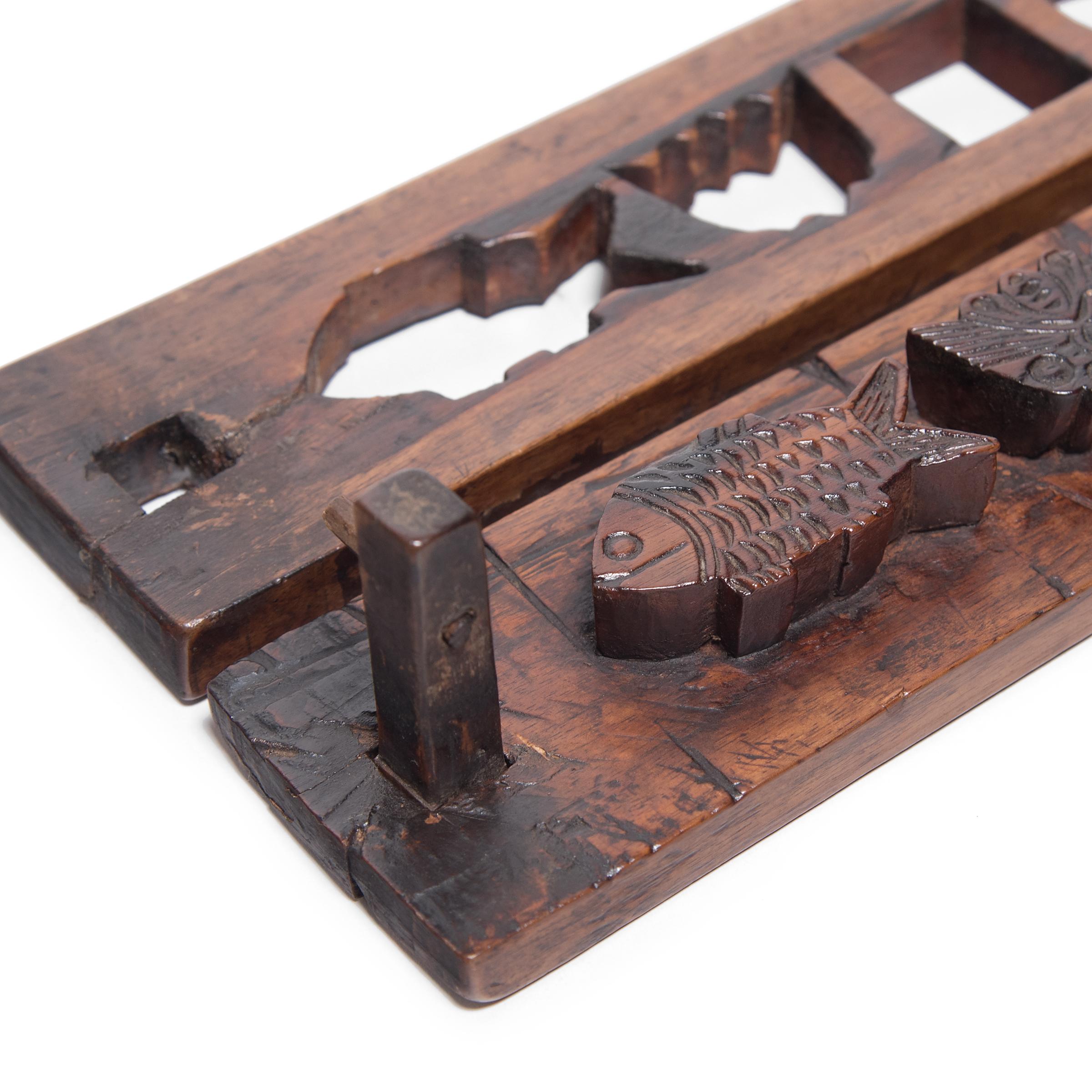 Dated to the mid-19th century, this rustic wood press is carved with seven unique molds used for shaping festive mooncakes. Packed with lotus root, red bean, or other regional fillings, mooncakes are a delicacy eaten during the Mid-Autumn Festival