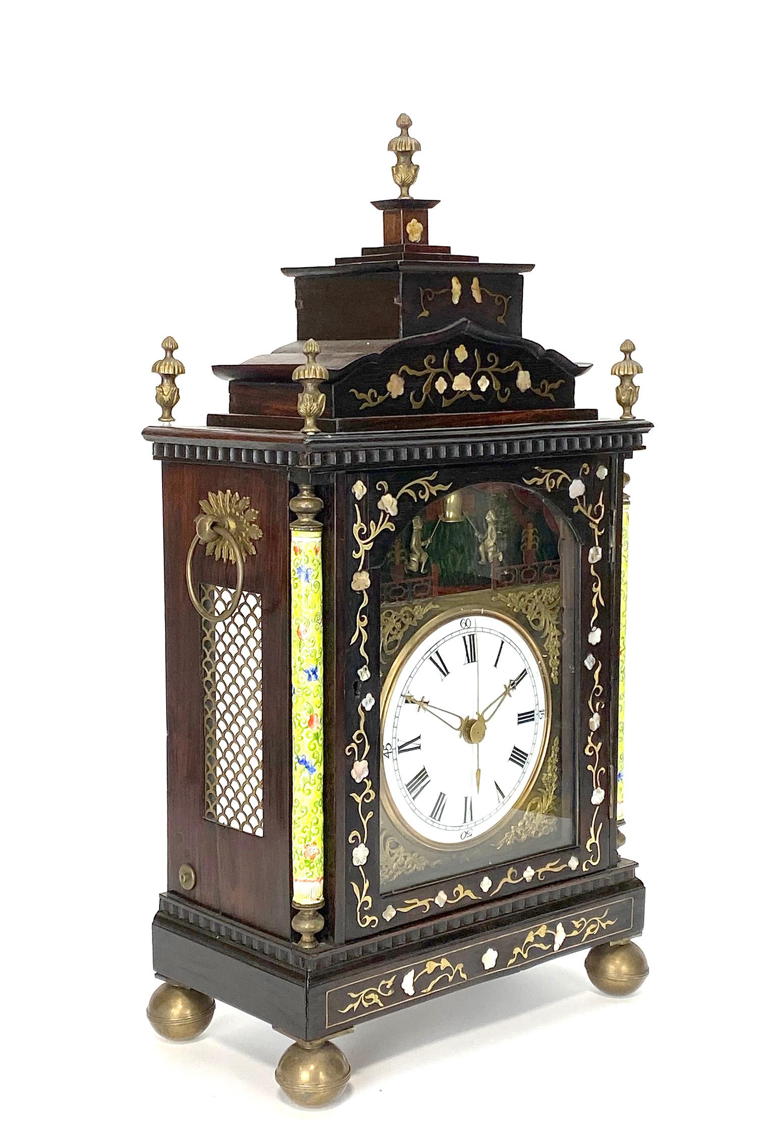 Here we are offering a rare Chinese rosewood bracket clock with enamel column on each side. Front case is inlaid with mother of pearl and nearly in perfect condition. 5 brass finials located on the top of the case. This clock has an 8 day fusee