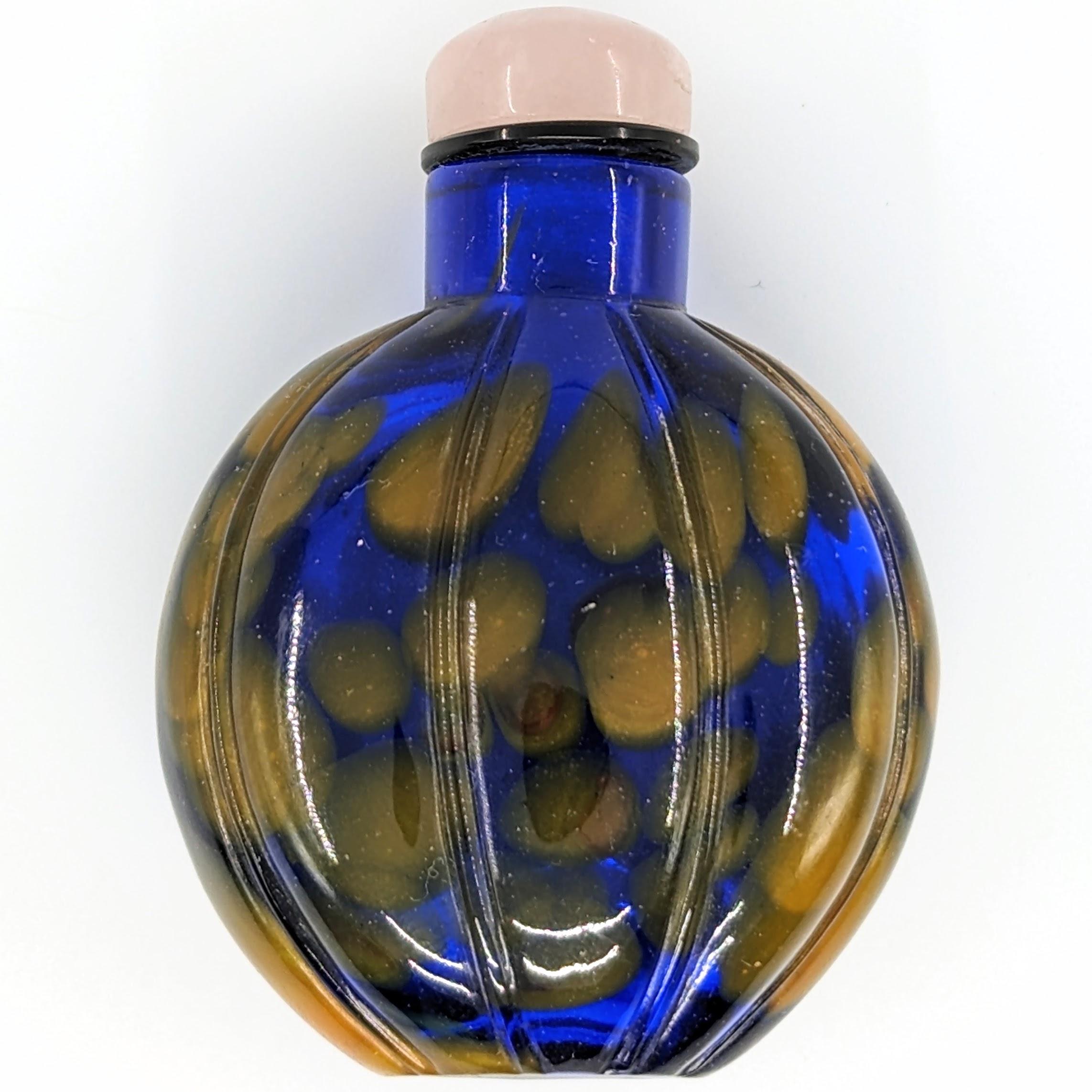Antique Chinese mottled Peking liuli glass snuff bottle, with well distributed spots of yellow on cobolt blue, with a rose quartz stopper

19c Qing Dynasty