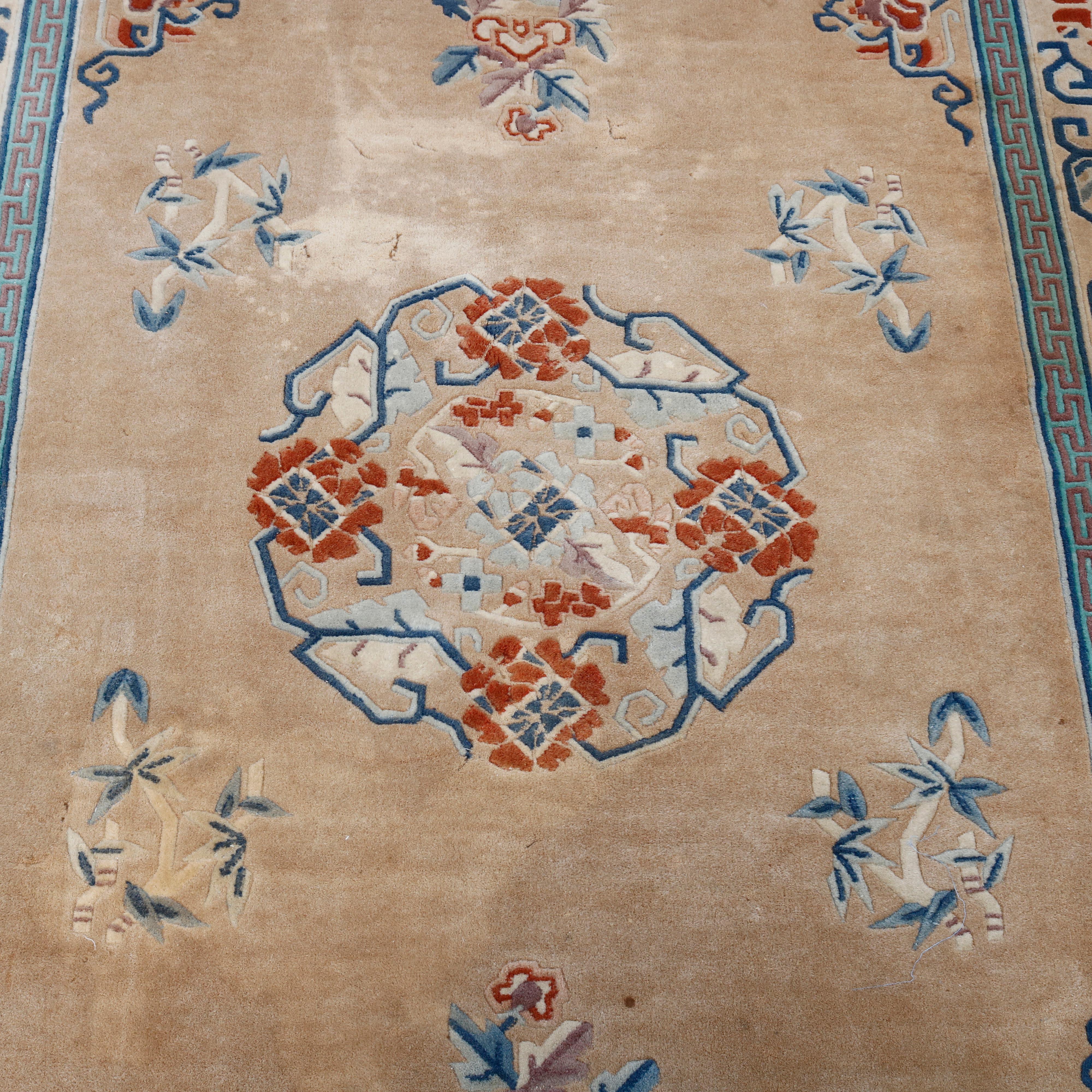 An antique Chinese Nichols oriental rug offers wool construction with rich saturated color having central medallion with detached bamboo on beige ground, 20th century

Measures: 77.5