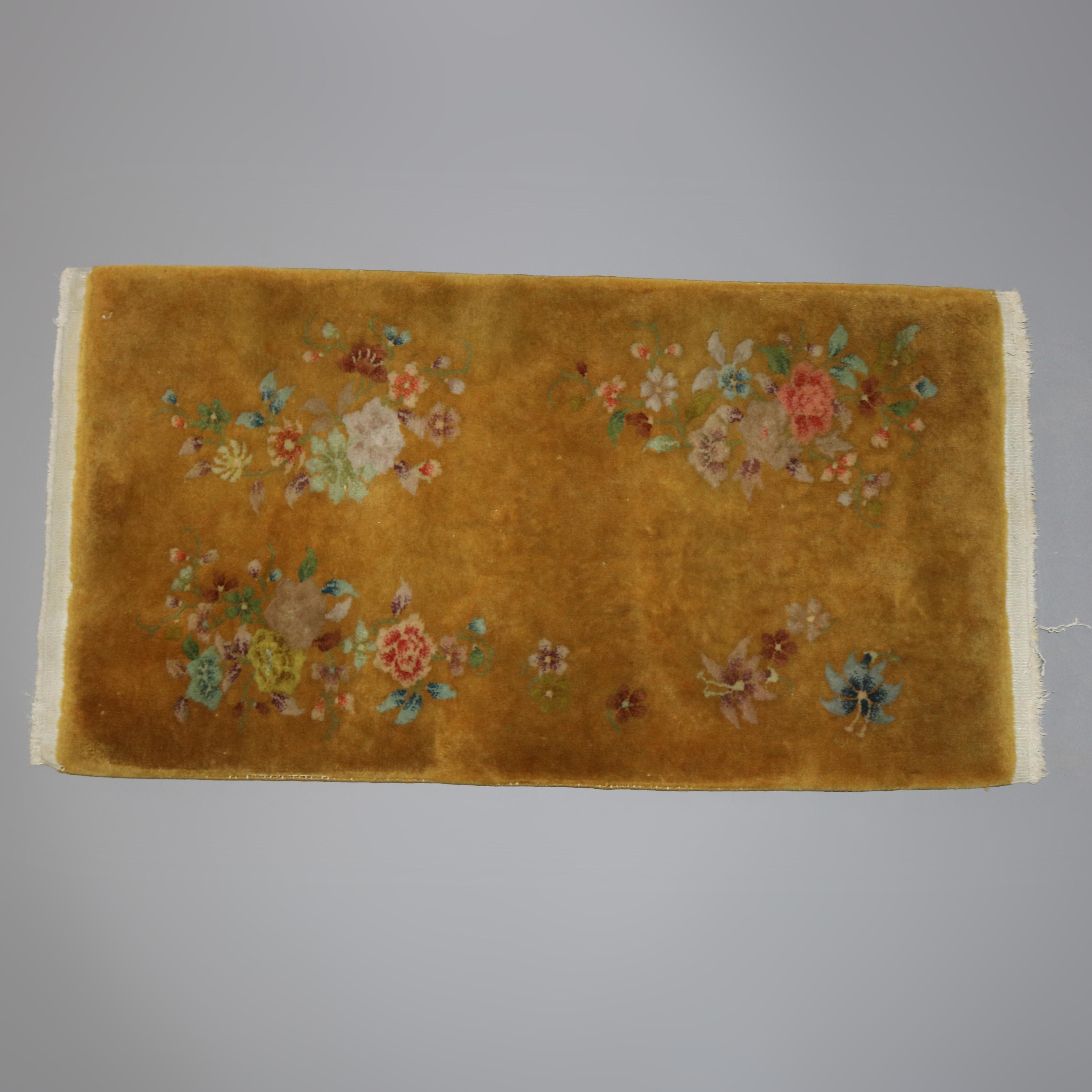 An antique Chinese Nichols style area rug offers wool construction with detached floral spray on gold ground, circa 1920

Measures: 27.5