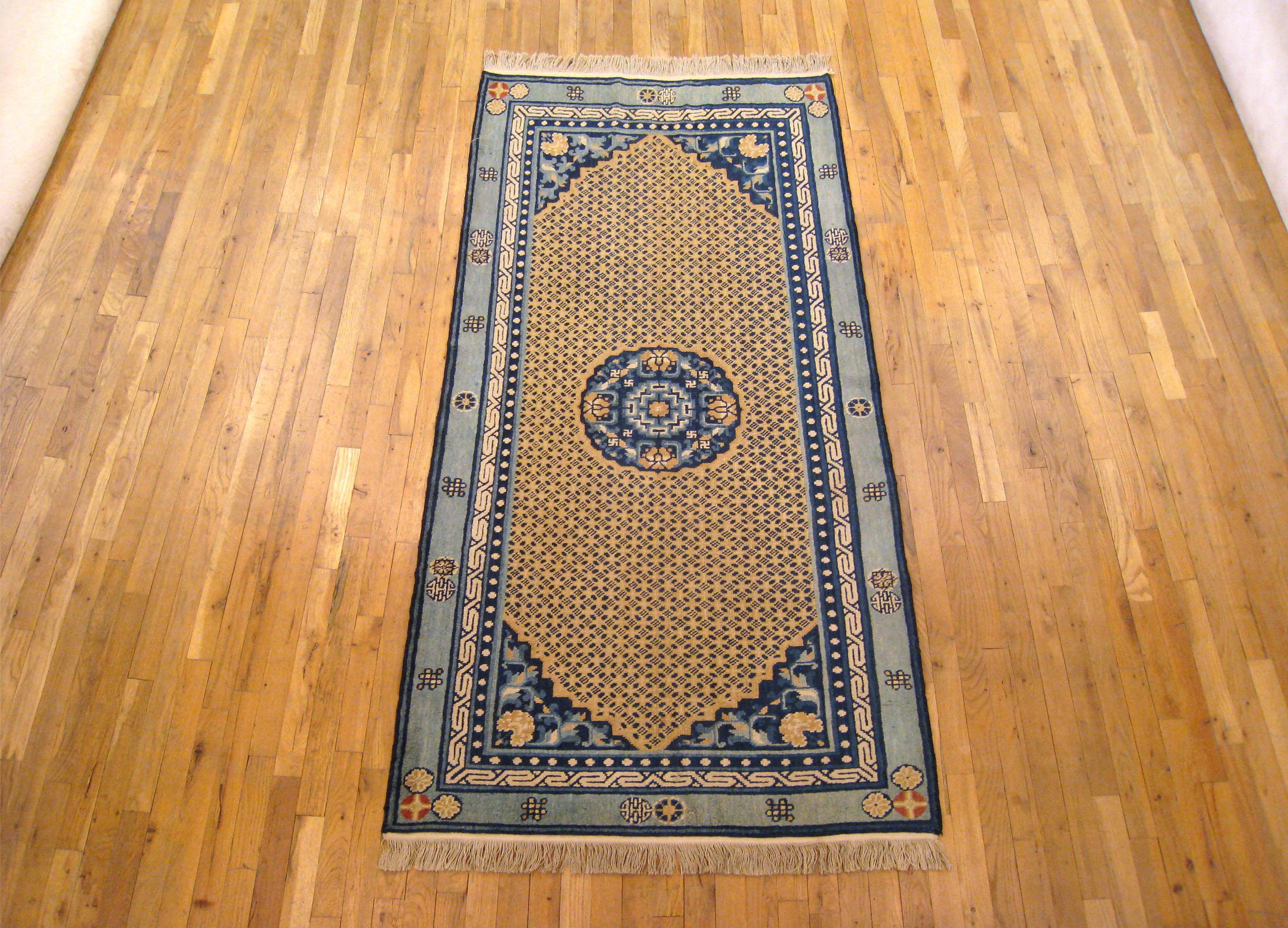 An antique Chinese Ning Xia oriental rug, circa 1890, size 7'3 x 3'6. This lovely rare textile features a blue medallion on a covered field, with blue corners, and a soft blue outer border. Various floral and oriental motifs appear throughout. An