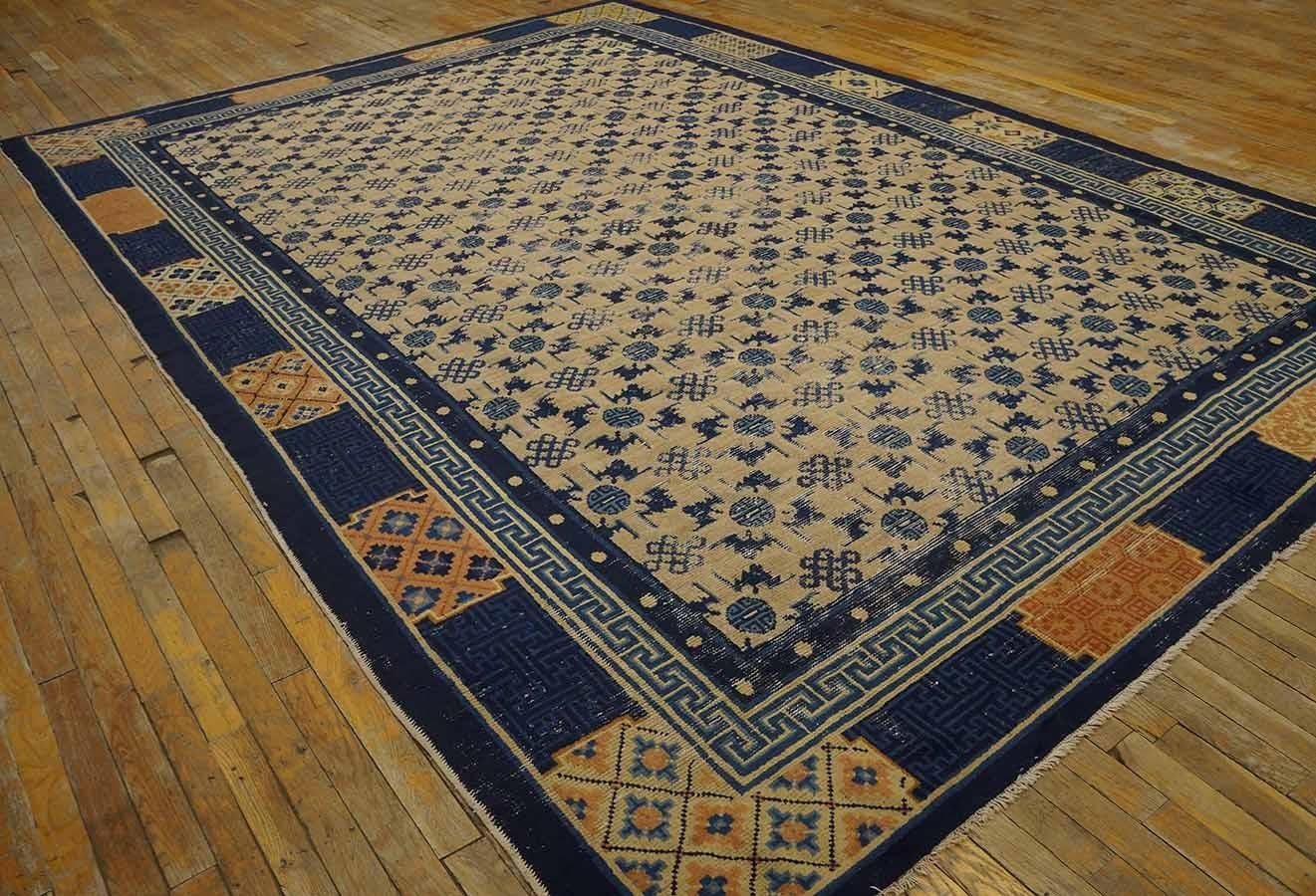 The creamy ivory ground of this northern Chinese carpet is decorated with an all-over design of bats, “shou” symbols and knots, within a cartouche border of textile patterns and an inner T-fret stripe. The iconography is that of good luck and long