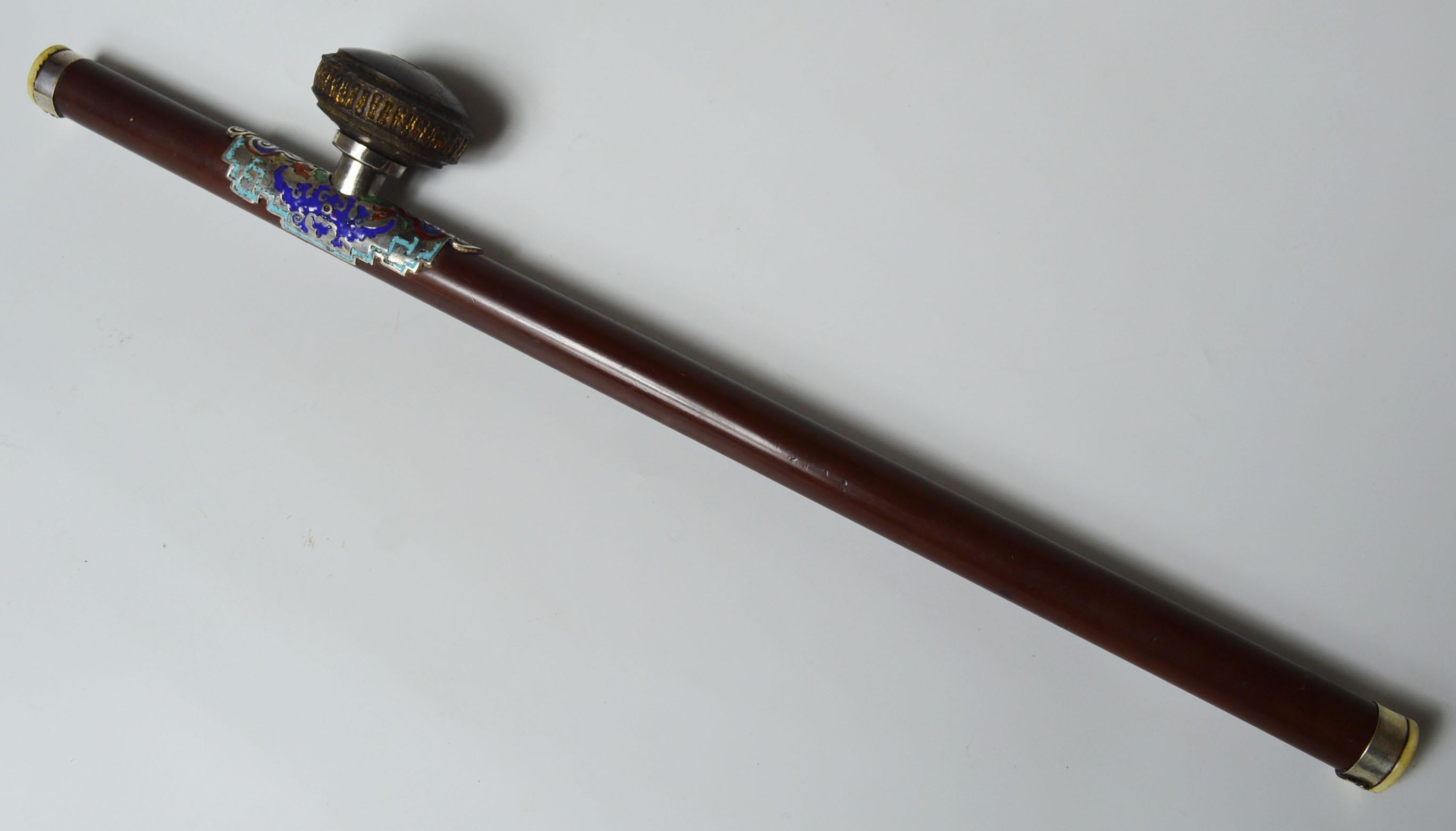 A fine antique Chinese opium pipe
Wood stem with enameled silver, bone ends with original ceramic damper
Period late 19th century.