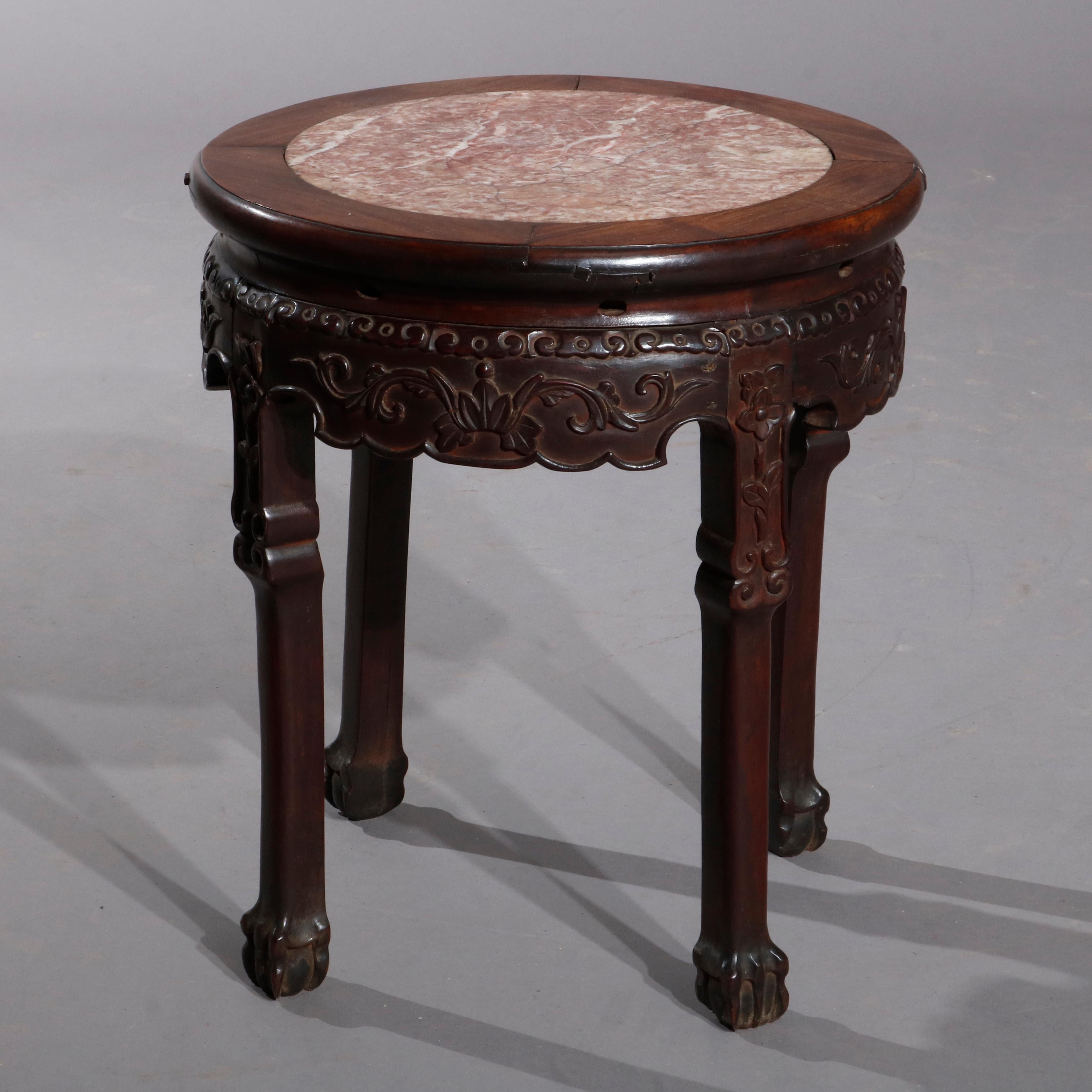 An antique Chinese Oriental fern or plant stand offers rosewood base with inset marble top and carved and shaped scroll and foliate skirt, raised on straight legs with stylized paw feet, circa 1900.

Measures- 18.5