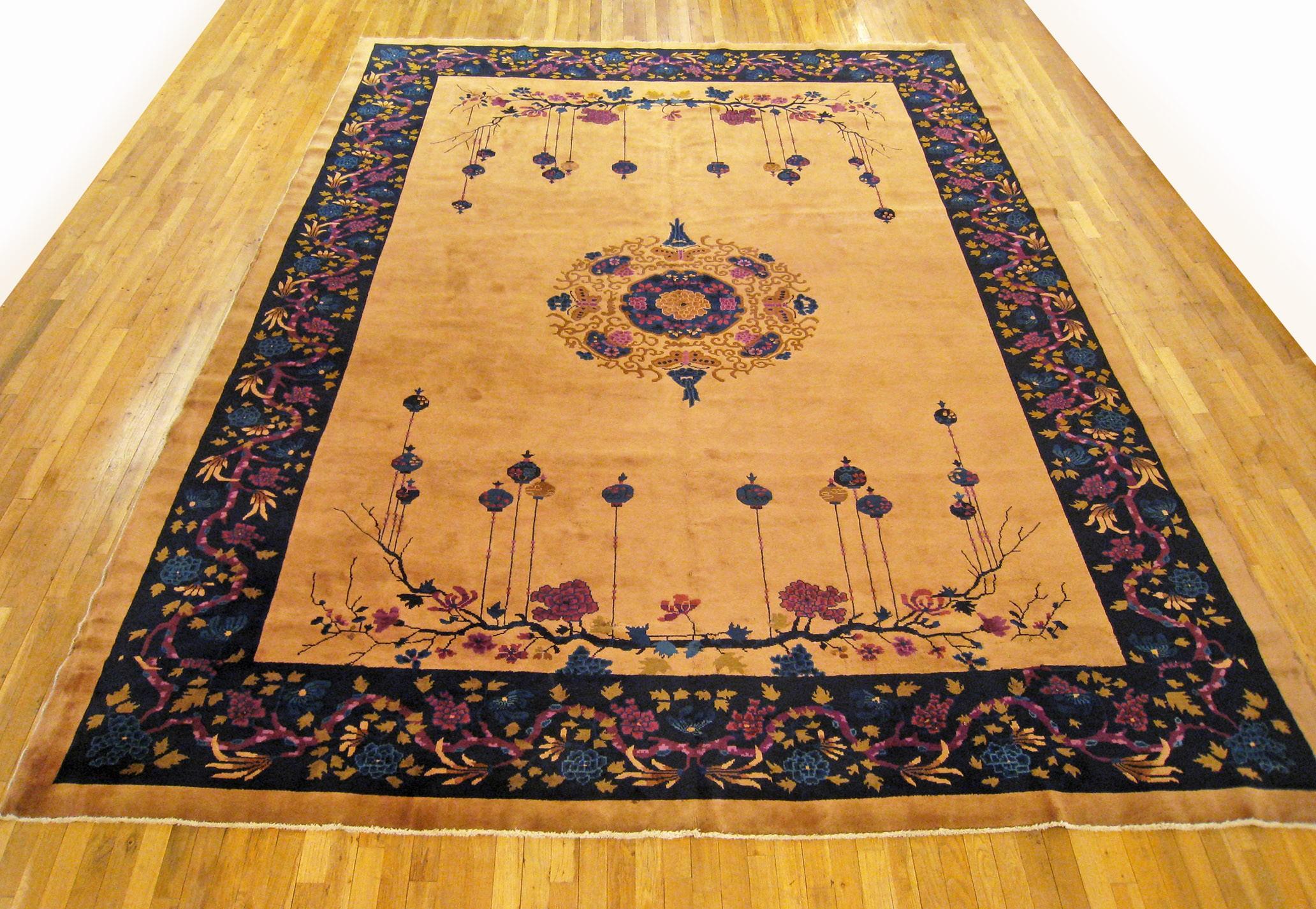 Antique Chinese rug, room size, circa 1920.

A one-of-a-kind antique Chinese oriental carpet, hand-knotted with medium thickness wool pile. This beautiful hand-knotted rug features chinese motifs and a central medallion on an open gold field, with a