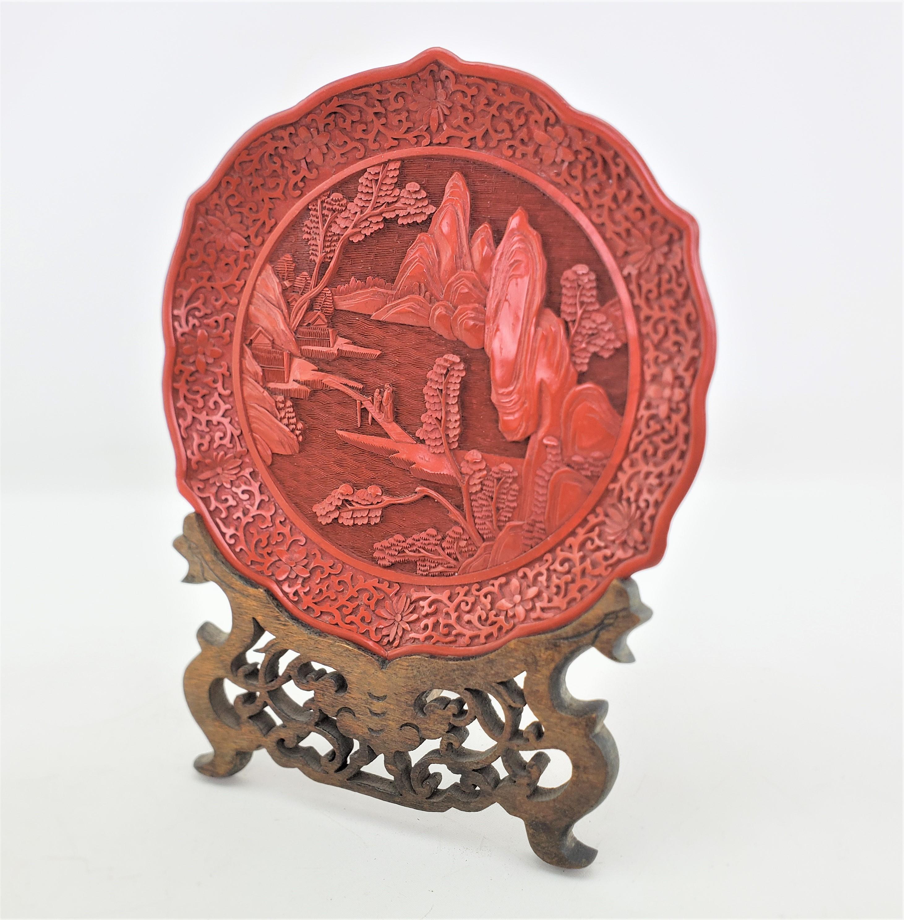 Chinese Export Antique Chinese Ornately Carved Cinnabar Plate with Landscape Scene & Wood Stand For Sale