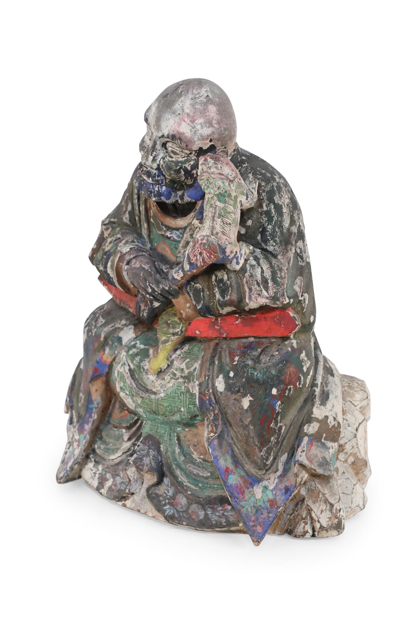 Antique Chinese (early 20th Century, Republic of China) clay Buddha sculpture with painted details in red, green, and blue.
    