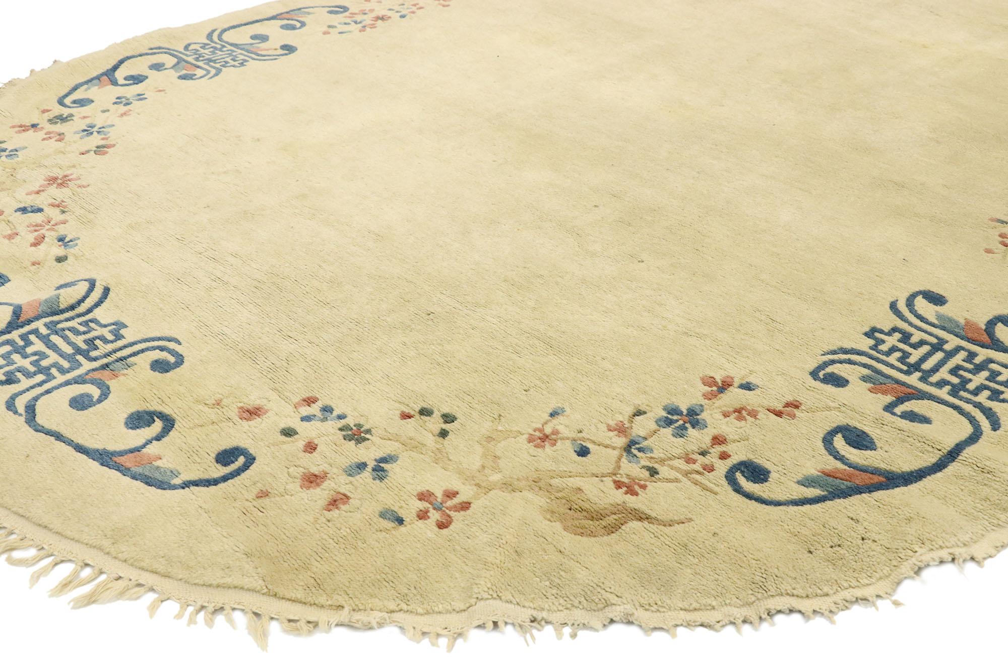 77451 antique Chinese Peking Oval rug with Romantic chinoiserie style. Recalling the surface designs of Fine China with light and airy colors, the simple, but graceful design dazzles the eye in this hand knotted wool antique Chinese Peking oval rug.