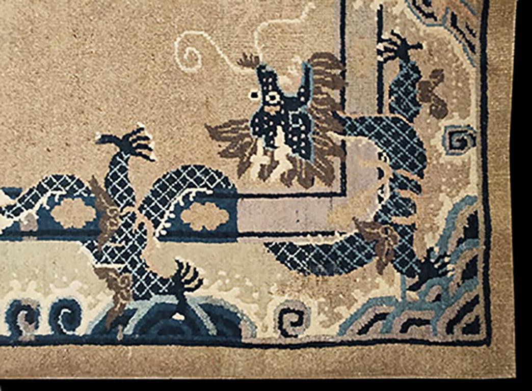 An imperial five clawed scaly and mustachioed dragon centers an open salmon field with four similar dragons wrapped around the inner border. Mountains and frothy waves decorate the matching border. 
The dragon is a benevolent creature in Chinese