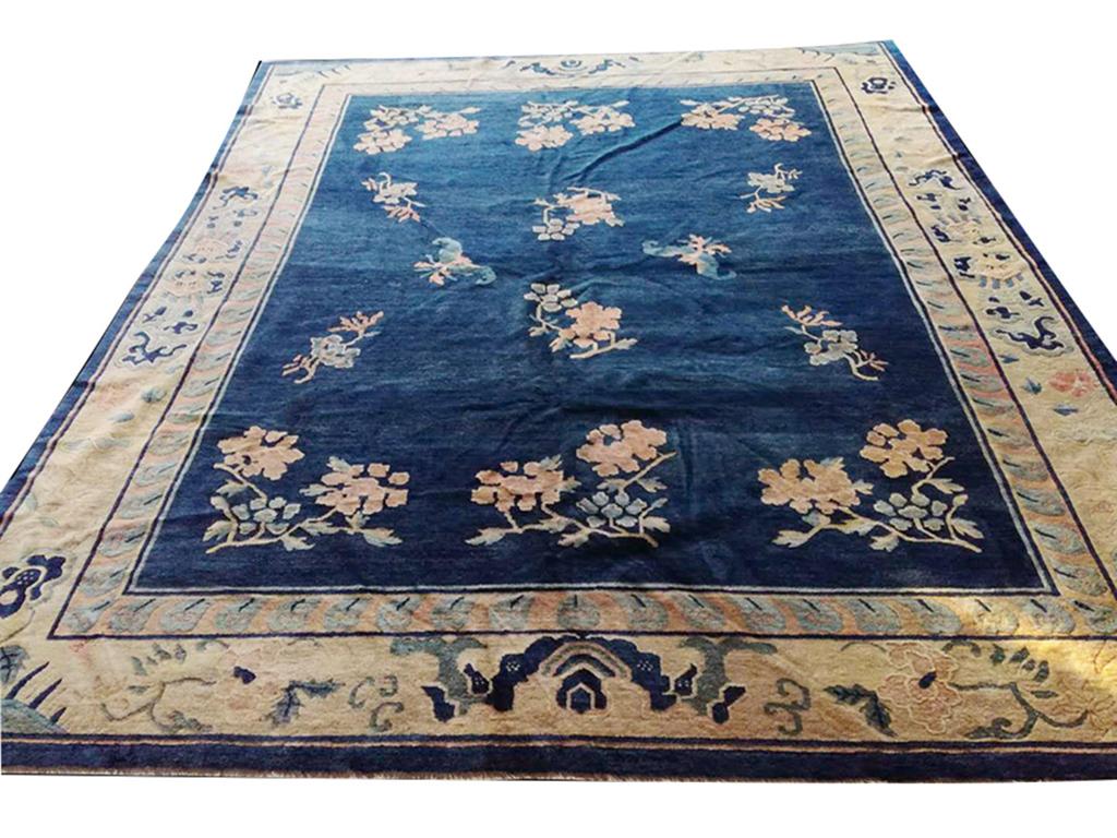 19th Century Chinese Peking Carpet with a navy background and ivory border.
( 8' x 9'6