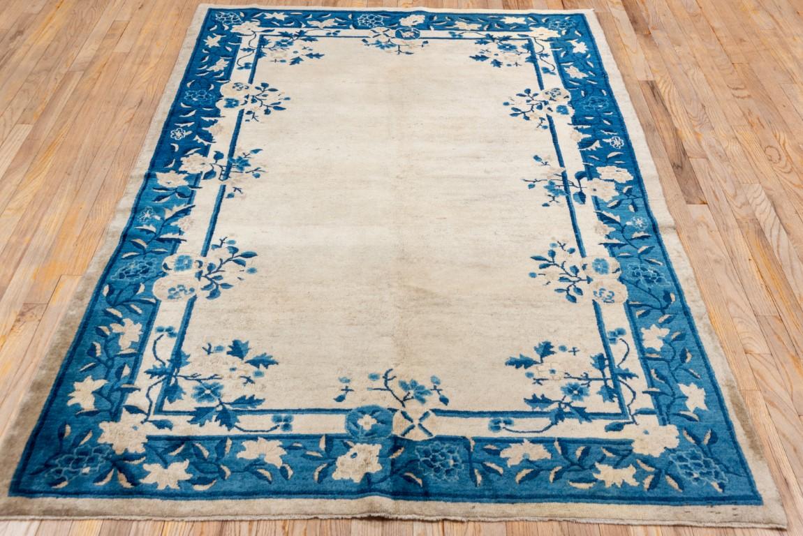 Hand-Knotted Antique Chinese Peking Rug with a Sand Field and Blue Border For Sale