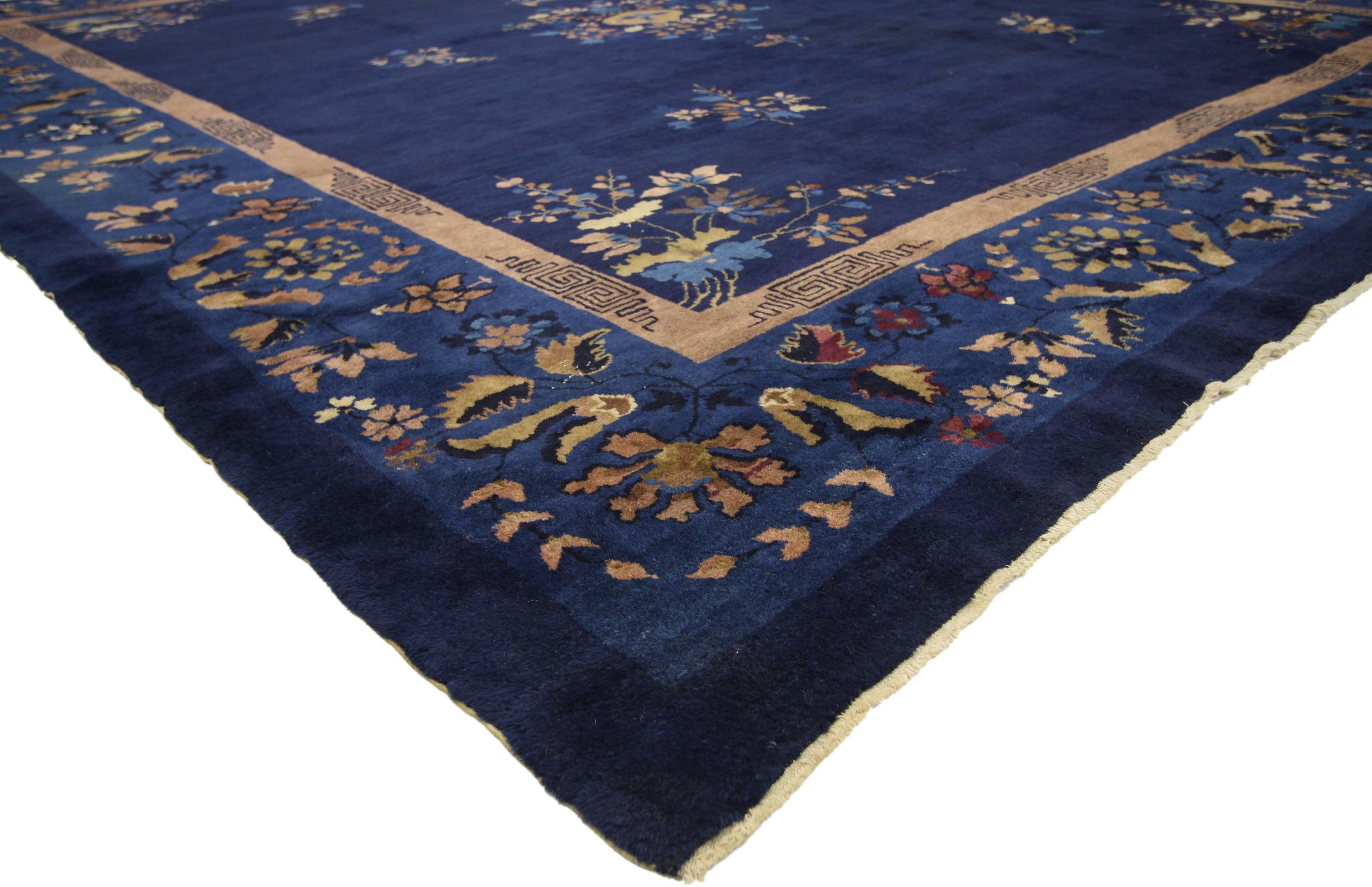 77140, antique Chinese Peking rug. Give a traditional room playfulness or warm up a modern space with this antique Chinese Peking rug featuring a chinoiserie Chic style. A simple yet striking flower bouquet and complementary floral spandrels are