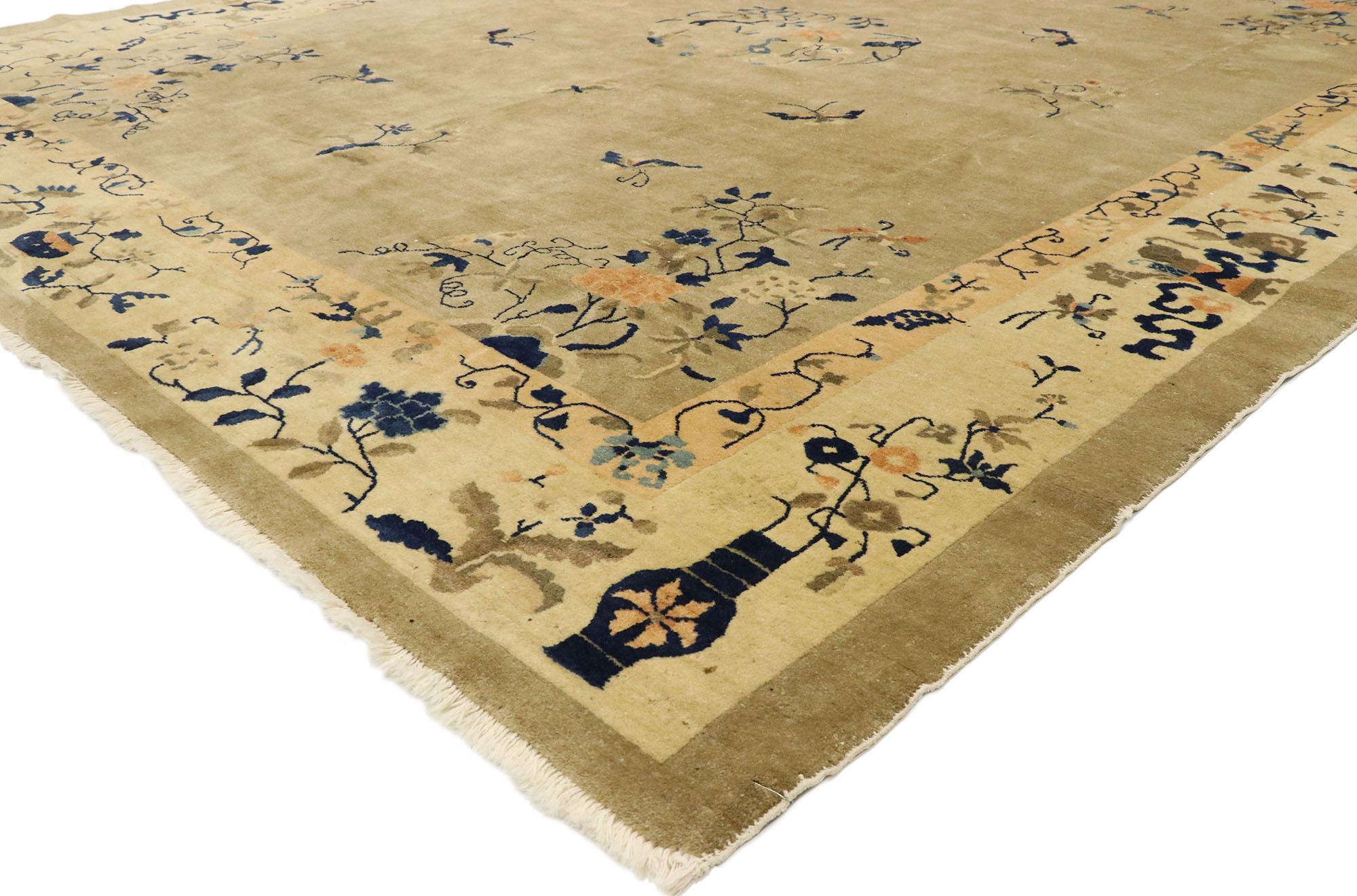 77445 antique Chinese Peking rug with chinoiserie Art Deco style. This hand knotted wool antique Chinese Peking rug features a rounded open medallion decorated with a lotus blossom, peonies, leafy tendrils, and a heron bird standing in a marsh