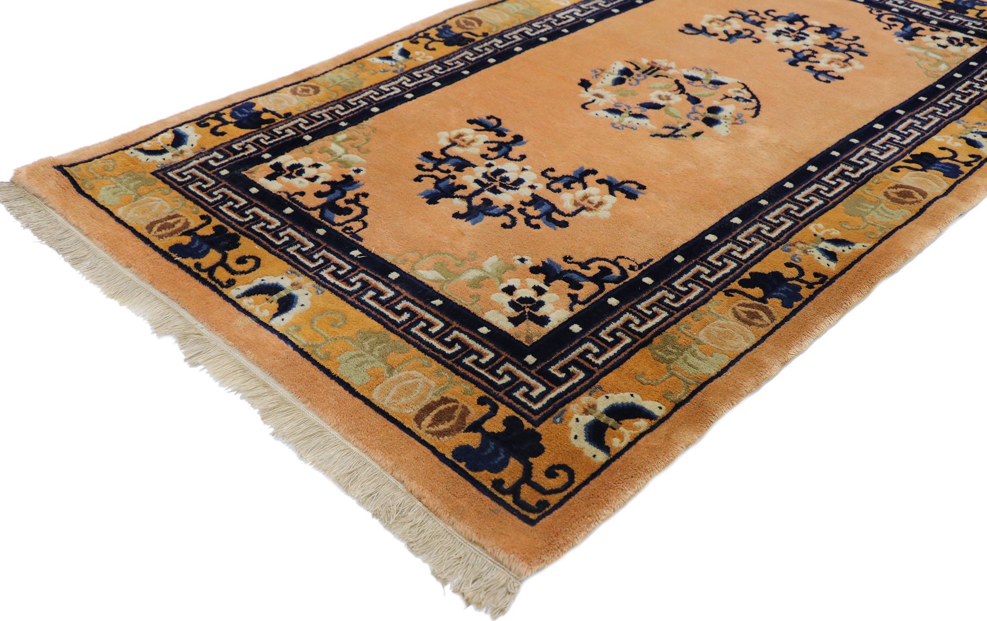 77591 Antique Chinese Peking rug with Chinoiserie Chic Style 03'00 x 05'01. This hand-knotted wool antique Chinese Peking rug features a rounded open center medallion floating on an abrashed orange hued field. The medallion is comprised of a swirl