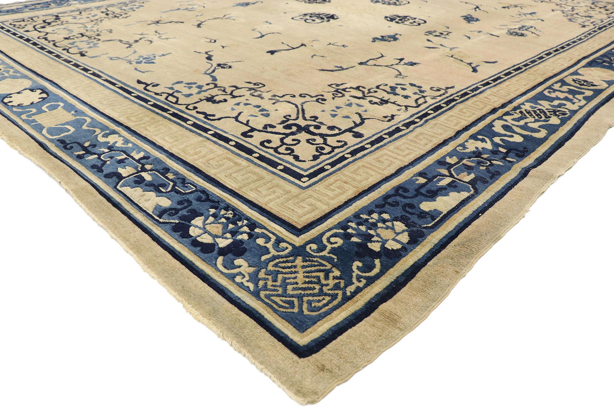 72991 Antique Chinese Peking Rug with Chinoiserie Style. Framed by an intricate blue border, this antique rug boasts a classic blue chinoiserie design that will never go out of style. The scattered tree branches meander in a compelling harmony,