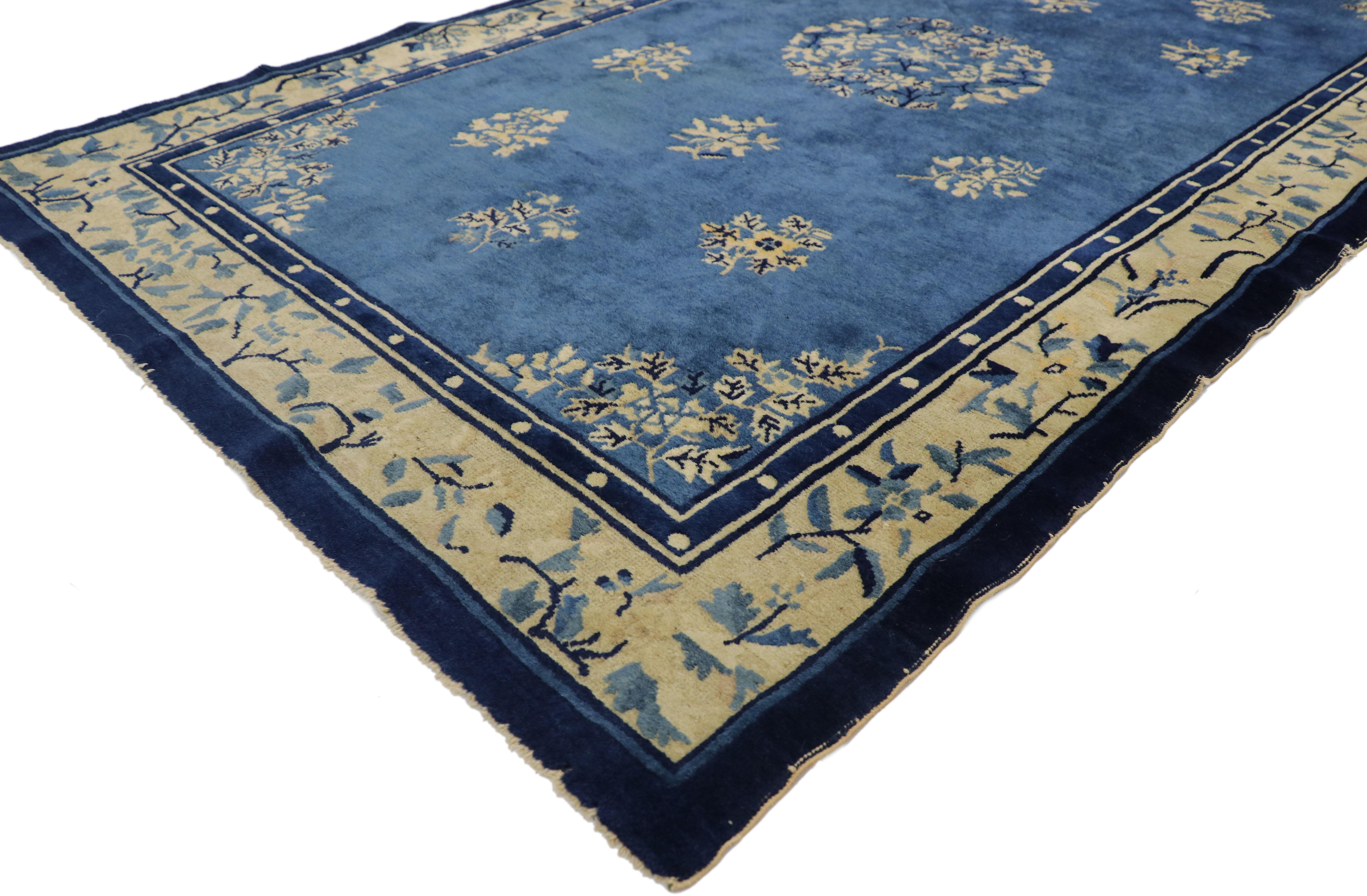 77330 Antique Chinese Peking Rug with Romantic Chinoiserie Style 04'01 x 06'09. This hand-knotted wool antique Chinese Peking rug features a rounded open floral medallion floating in the center of an abrashed blue field surrounded by a constellation