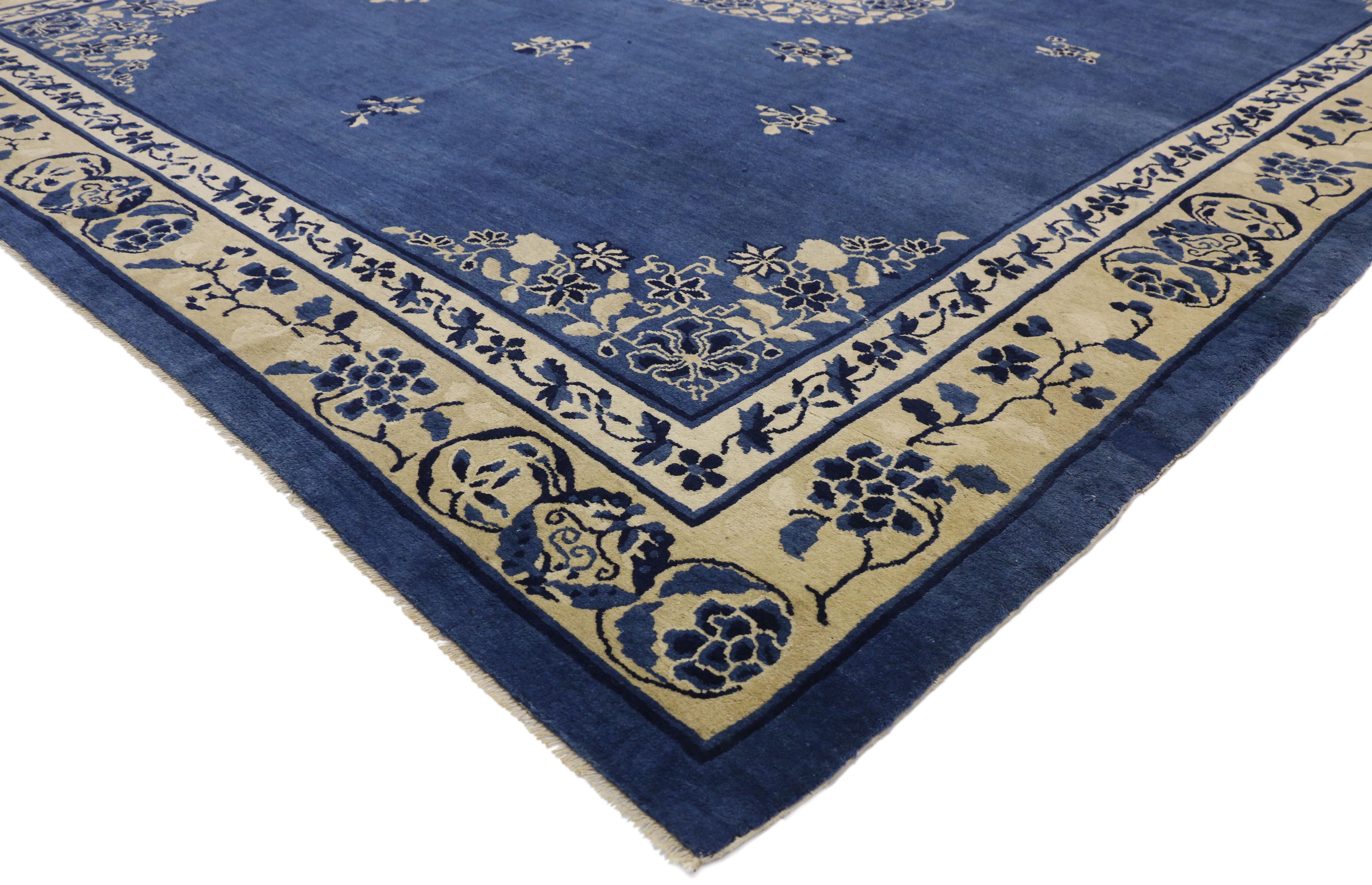 77241 Antique Chinese Peking Rug with Romantic Chinoiserie Style 09'00 x 11'04. This hand-knotted wool antique Chinese Peking rug features a rounded open center medallion decorated with a swirl of peonies and leafy tendrils floating in the center of