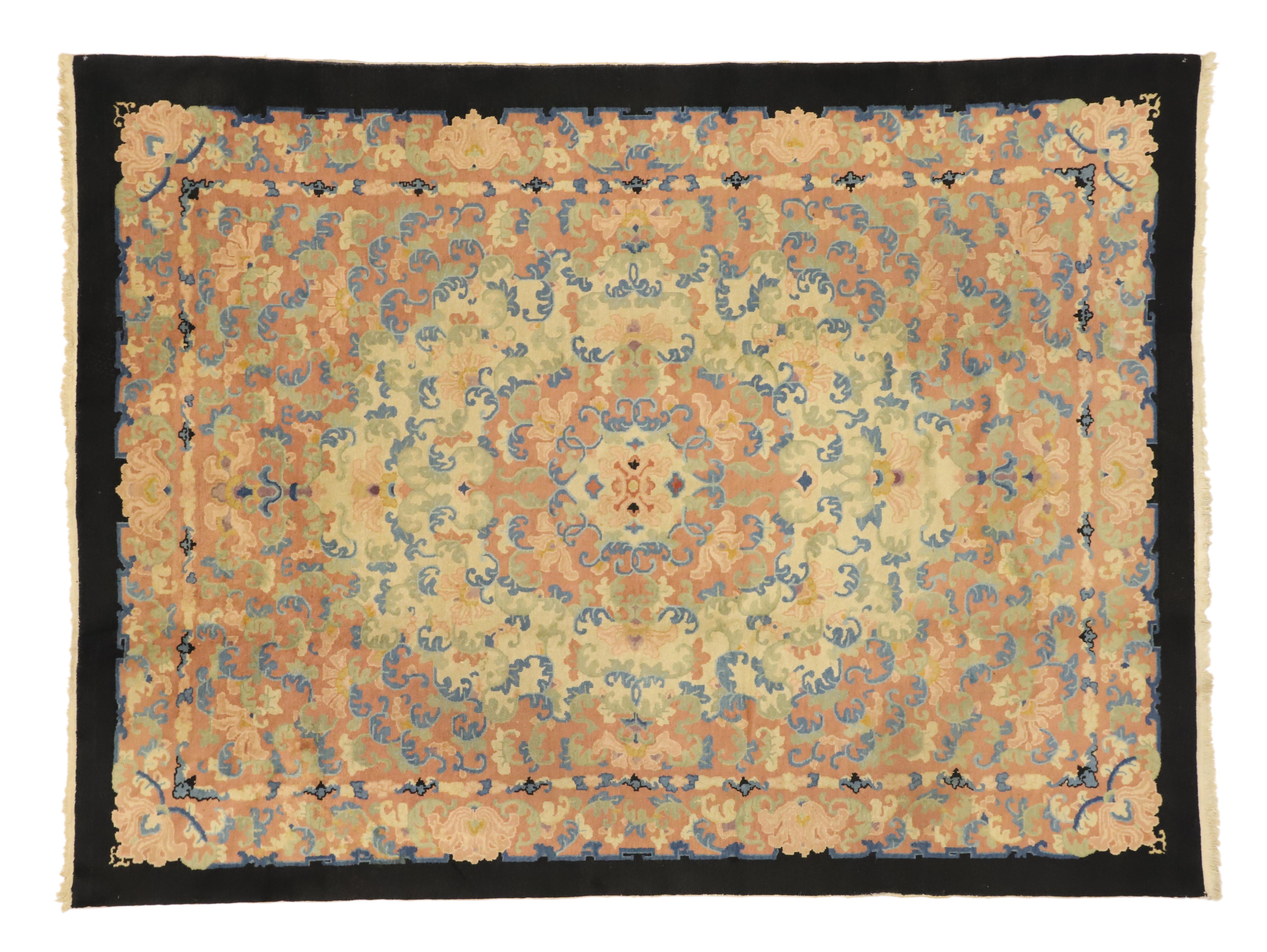 70240 Antique Chinese Peking Rug with Romantic French Country Style. This hand-knotted wool antique Chinese Peking rug was produced at the turn of the century. It features a round centre medallion surrounded by an all-over floral pattern of