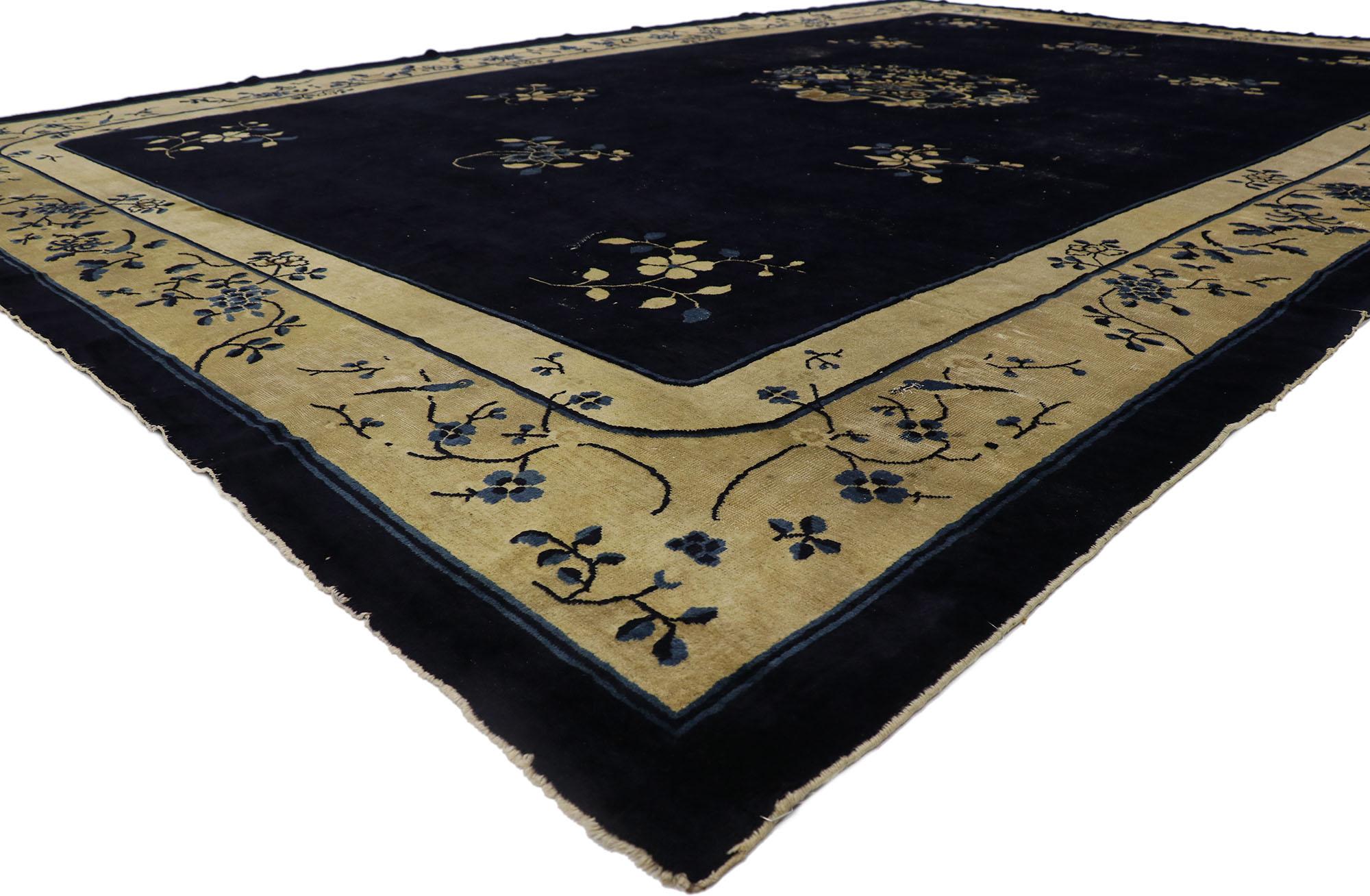 78131 Distressed Antique Chinese peking rug with Rustic Chinoiserie Style 12'02 x 18'02. This hand knotted wool antique Chinese Peking rug features a rounded open medallion decorated with a large open lotus blossom, peonies, and leafy tendrils
