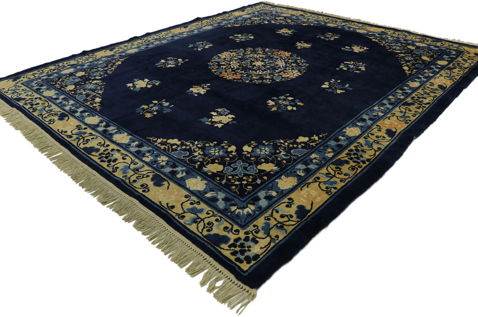 77542 Antique Chinese Peking rug with Traditional Chinoiserie style. This hand knotted wool antique Chinese Peking rug features a rounded open center medallion decorated with a swirl of peonies, lotuses, and leafy tendrils floating in the center of