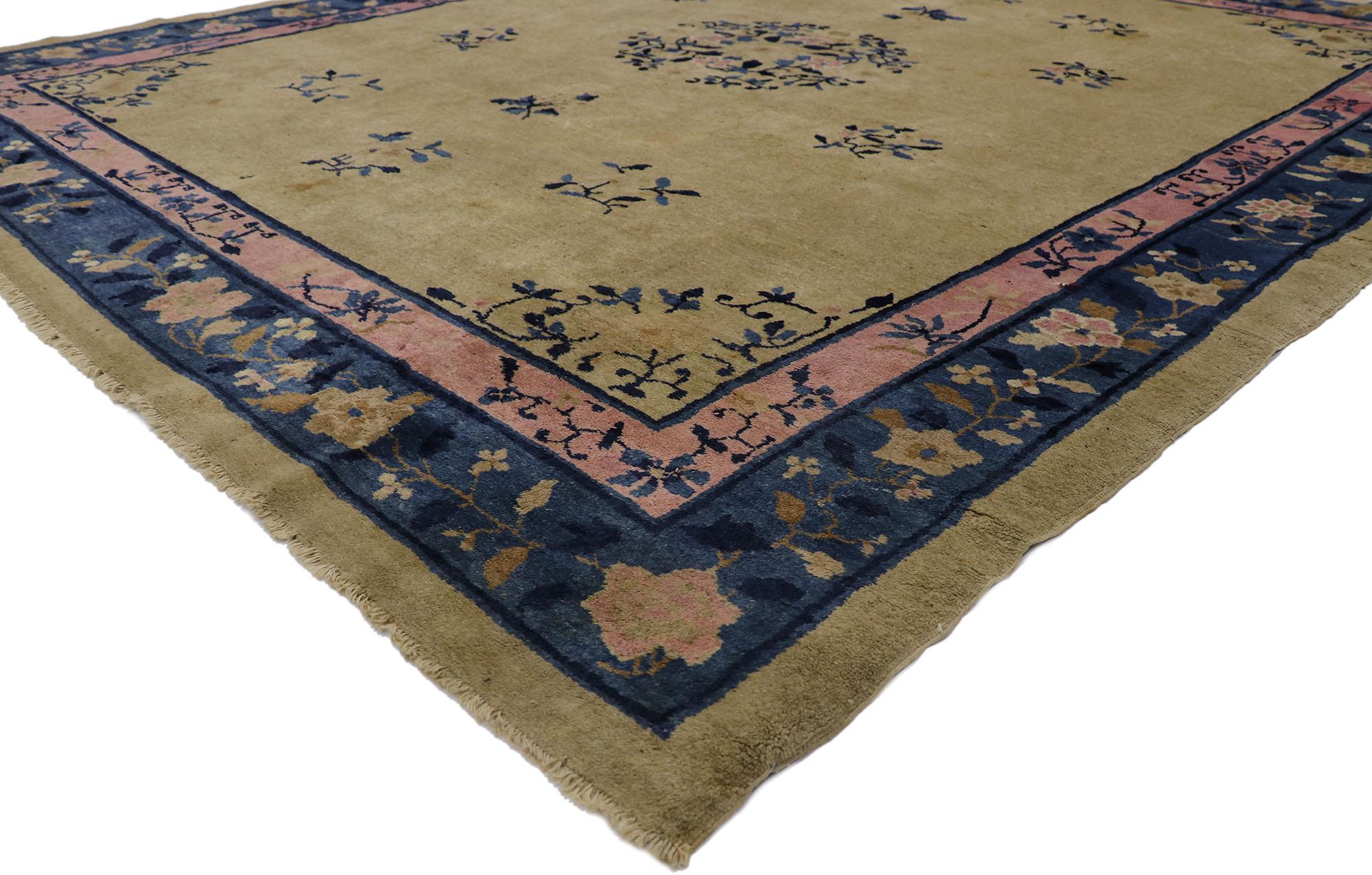 78130 Antique Chinese Peking Rug with Traditional Chinoiserie Style 08'03 x 09'08. This hand-knotted wool antique Chinese Peking rug features a rounded open medallion decorated with a large open lotus blossom, peonies, and leafy tendrils floating in
