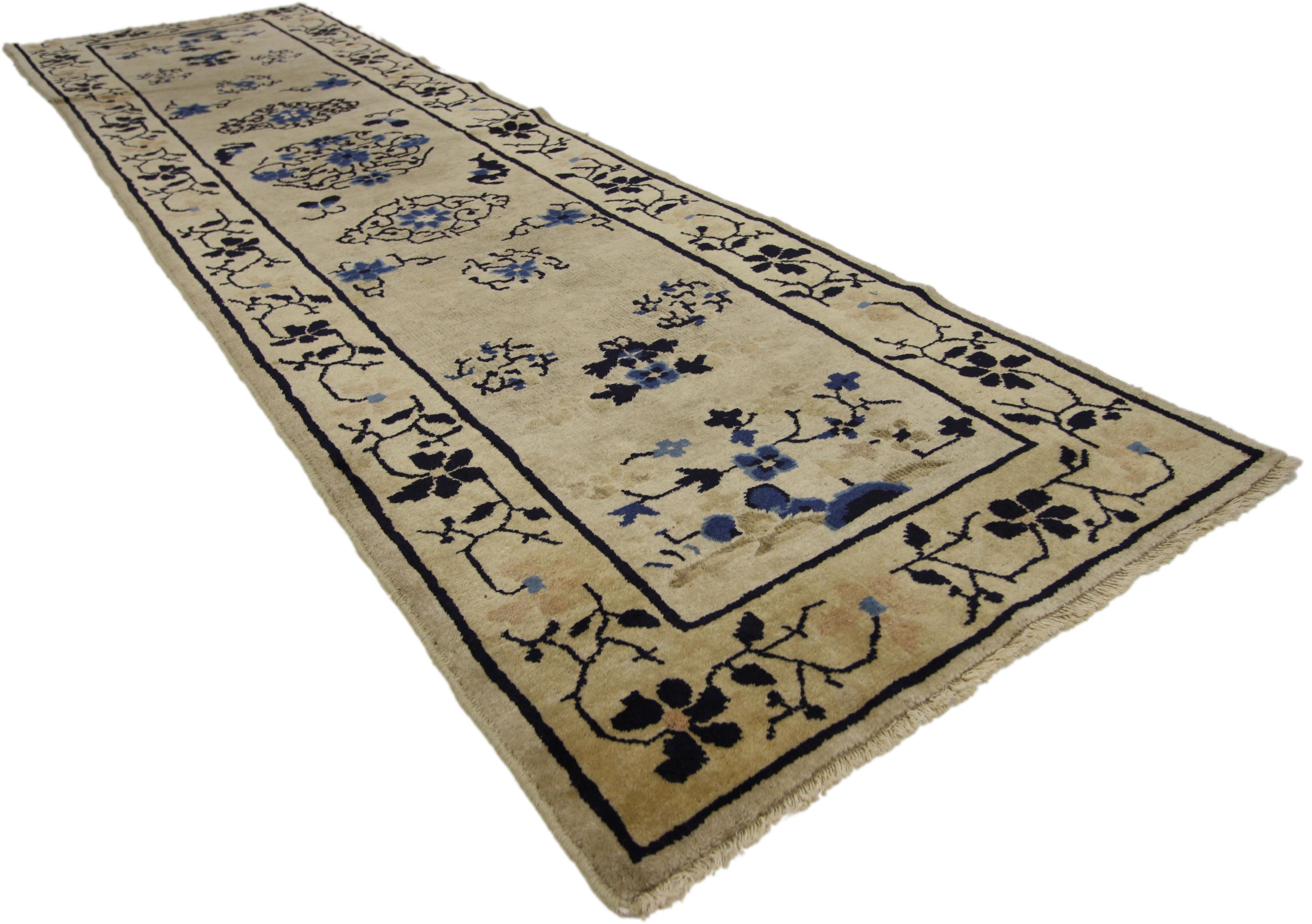 77173, antique Chinese Peking runner with chinoiserie Chic style - Hallway runner. This hand-knotted wool antique Chinese Peking features three medallions with sparse floral sprays on an open ground abrashed greige field. Two thin black lines create