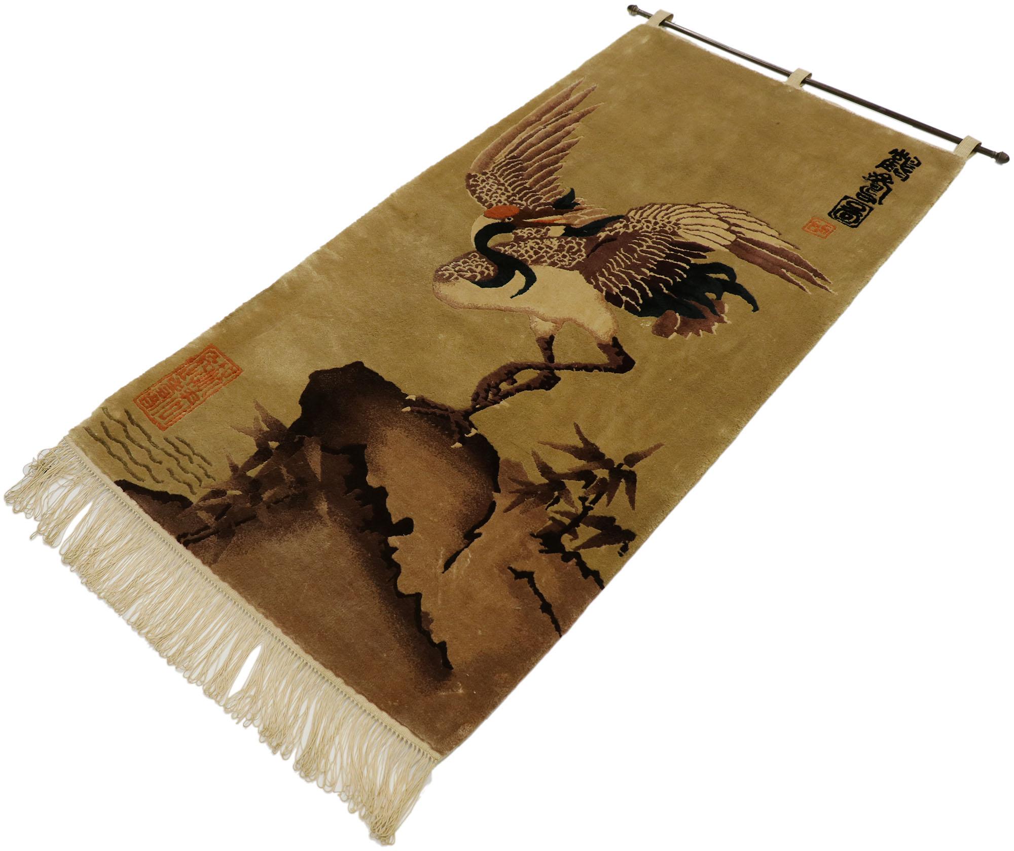 77548, antique Chinese pictorial tapestry with traditional crane design. This hand knotted wool antique Chinese pictorial tapestry features a large red-crowned crane design set against an abrashed neutral field. The crane is depicted standing on one