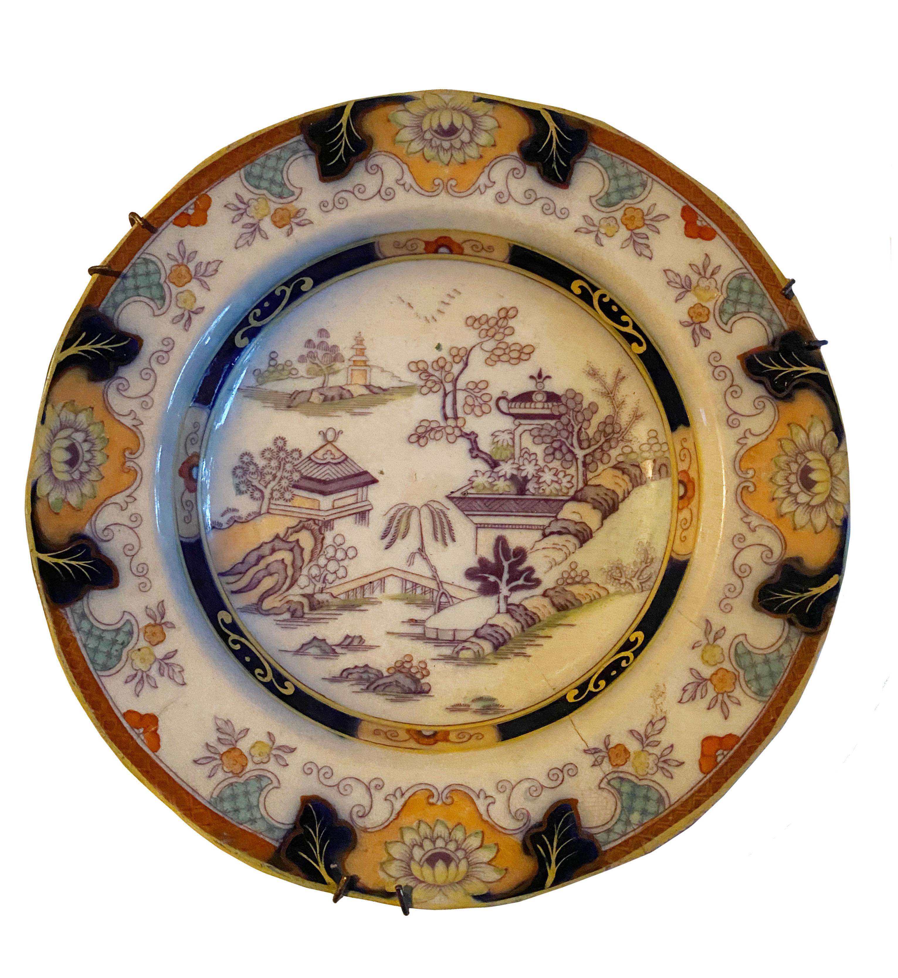 A pair of Tongzhi Period (1862-1874) Chinese polychrome plates. Dated on the reverse 1873. Beautiful muted colors in these plates. With wall hangers.