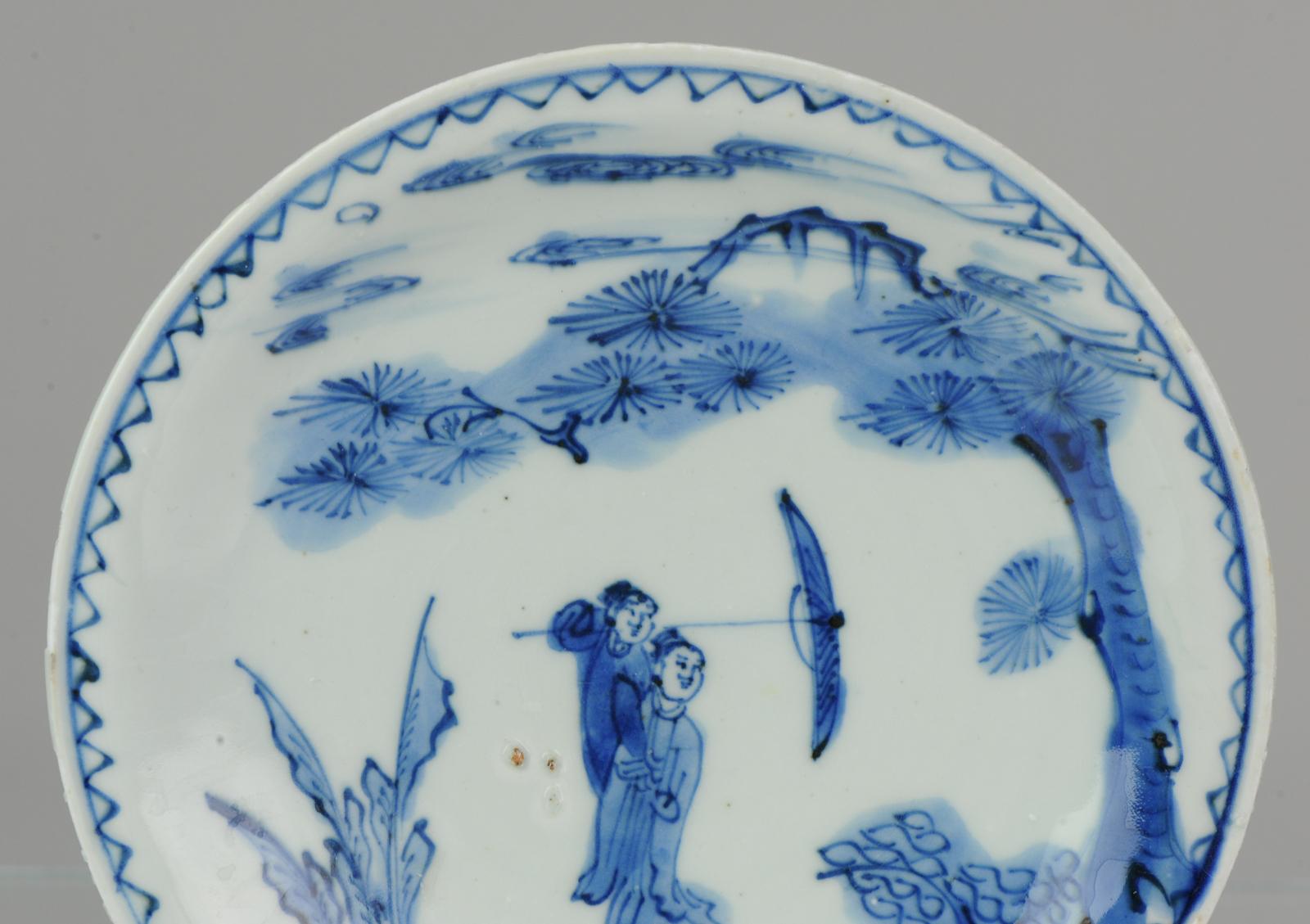 A very nicely decorated kosometsuke plate with a rare scene suggesting an secret romantic meeting, a lady and umbrella-bearing gentleman closely together beneath a long overhanging pine tree beside bamboo and plantain, the scene moonlit and misty at