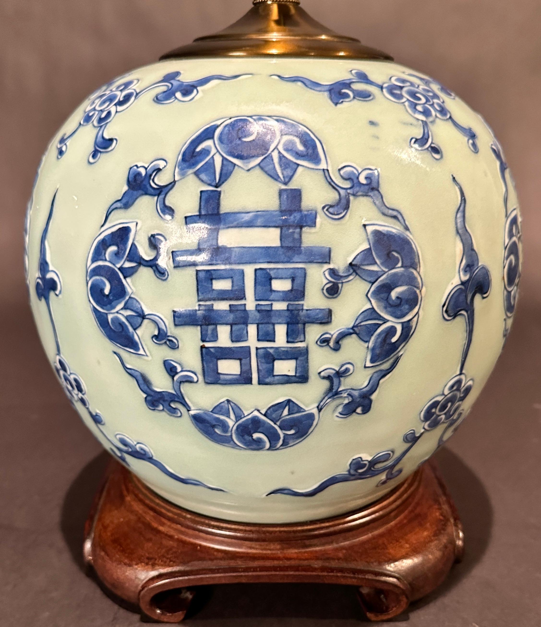 Ancien pot à gingembre en porcelaine chinoise bleu et blanc sur céladon transformé en lampe. Motif de double bonheur peint à la main avec décoration florale. Monté sur une base en bois de rose.
16