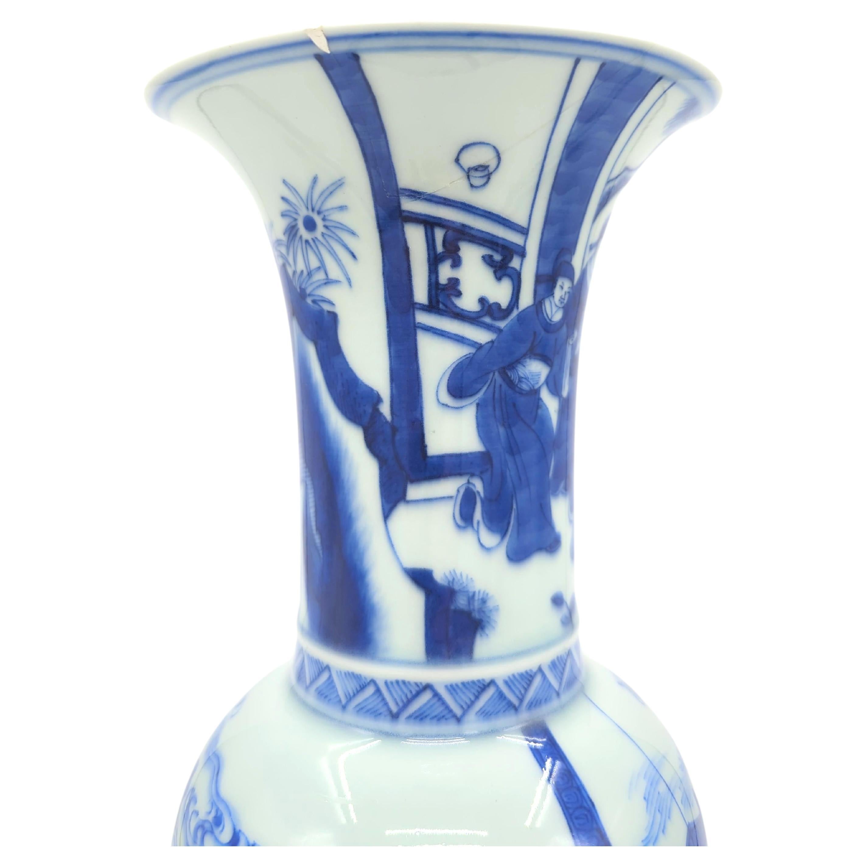 This late Qing to early Republic of China period Gu vase, stands as a testament to the enduring artistry of Chinese blue and white porcelain, in the revered Kangxi style. The vase is masterfully painted with figures in traditional Qing attire, who
