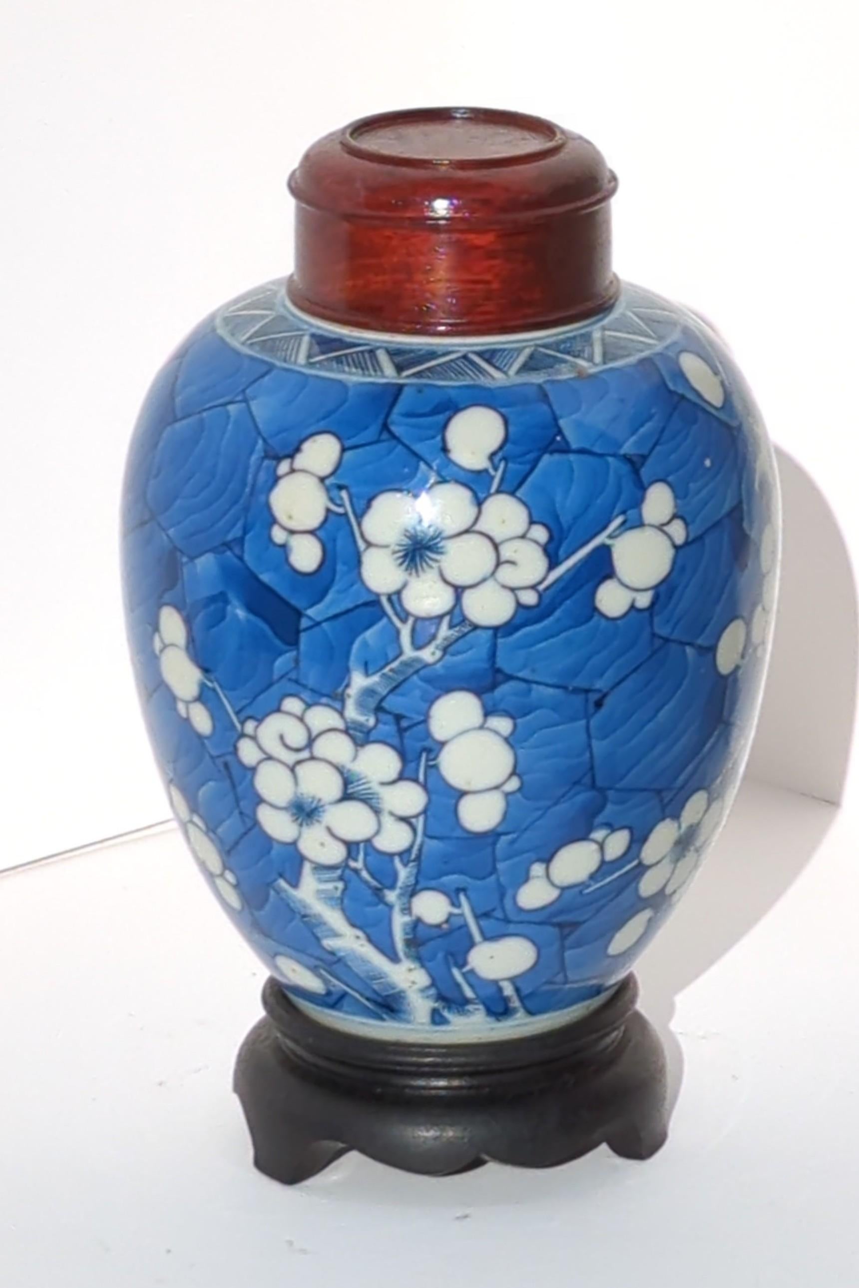Antique Chinese Qing Dynasty Kangxi period blue and white ovoid ginger jar, finely hand painted in underglaze blue and white, with reserve blooming prunus branches on hawthorn style, underglaze cobalt blue wash ground, and double circle mark in