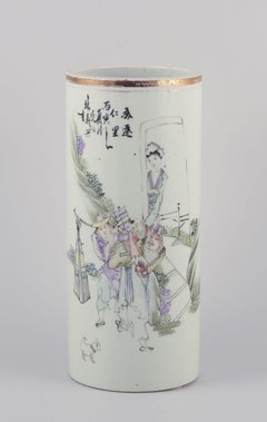 Antique Chinese porcelain brush holder with a motif of figures in a landscape.