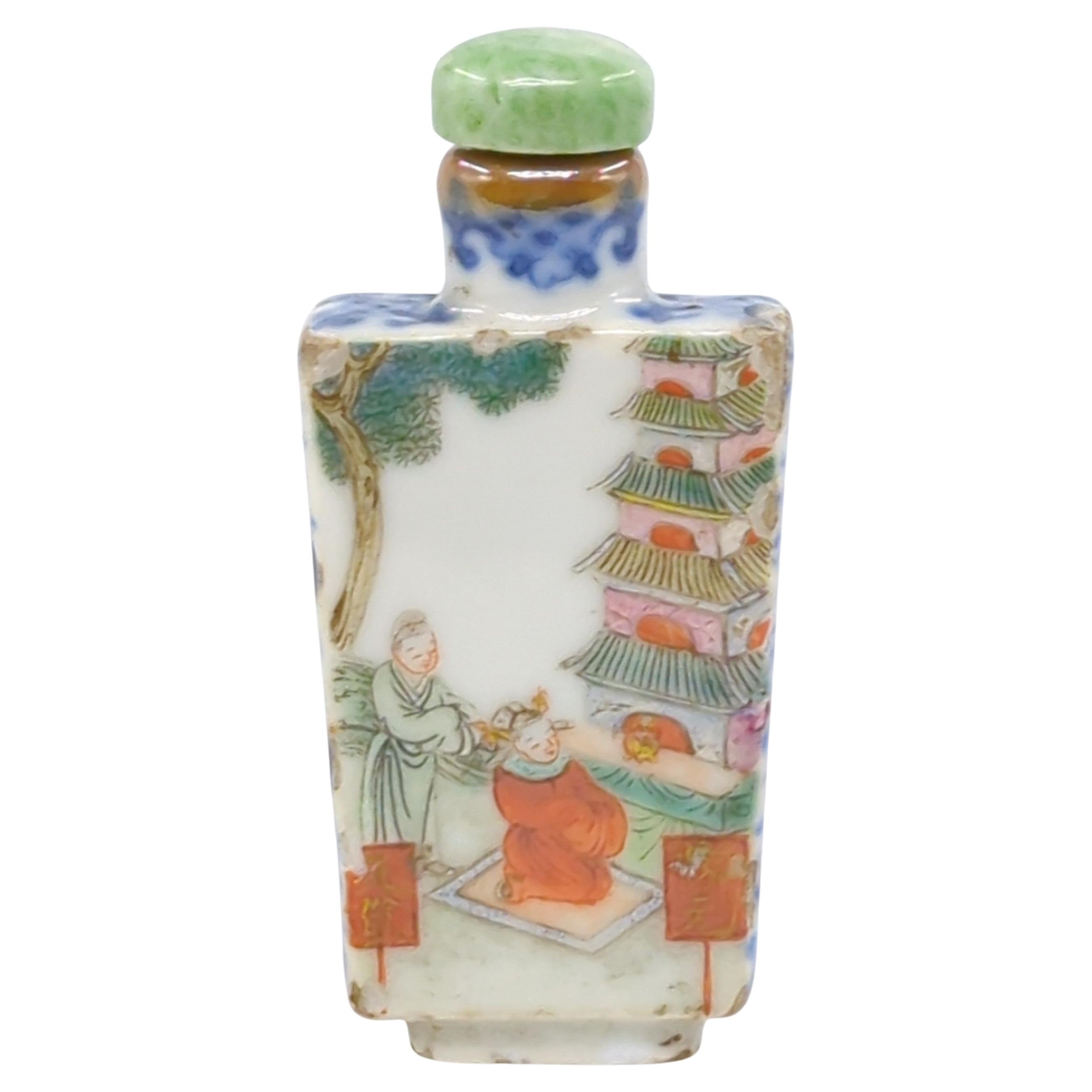 This fine Chinese porcelain snuff bottle from the Qing Dynasty's Jiaqing period  is of a tapered rectangular form, a shape that combines elegance with a sense of sturdiness.

The top and sides of the bottle are adorned with underglaze blue