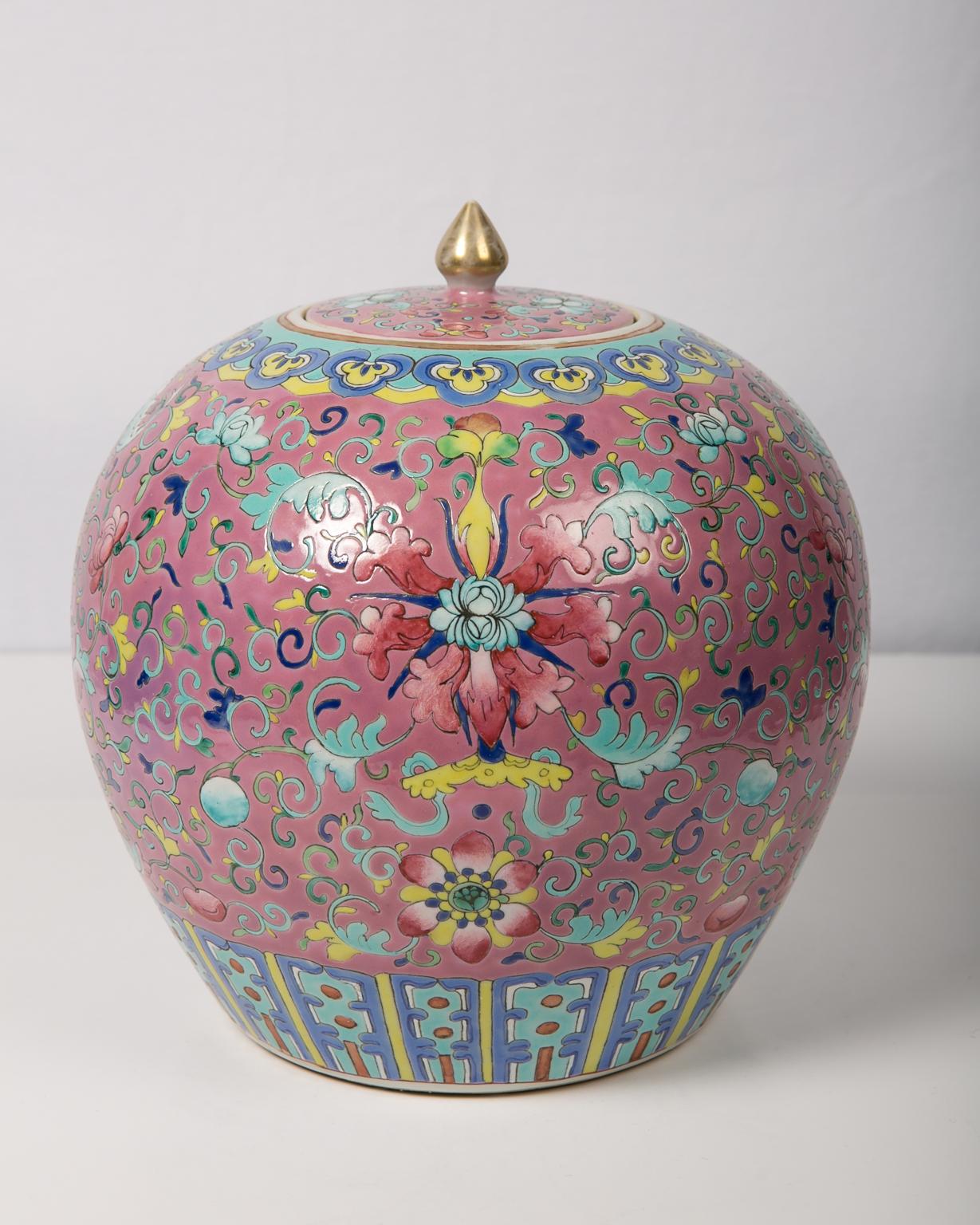An ornate Chinese ginger jar dated to the second half of the 19th century. The patterns are set against a soft pink background, a color scheme that became popular beginning in the Qianlong period. The jar is richly decorated with flowers, bats, and