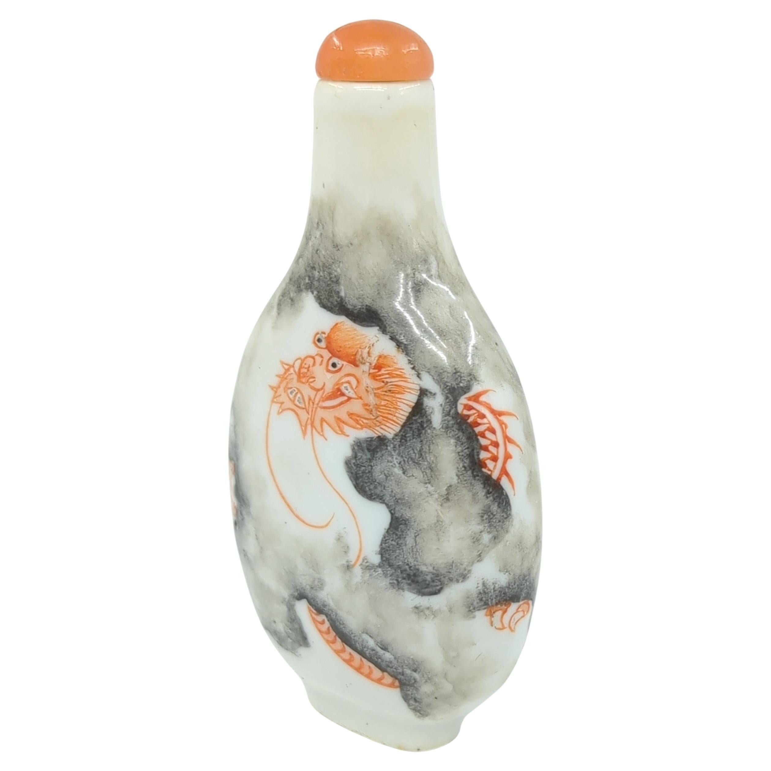 This fine Chinese porcelain snuff bottle is a beautiful example of fencai, or 