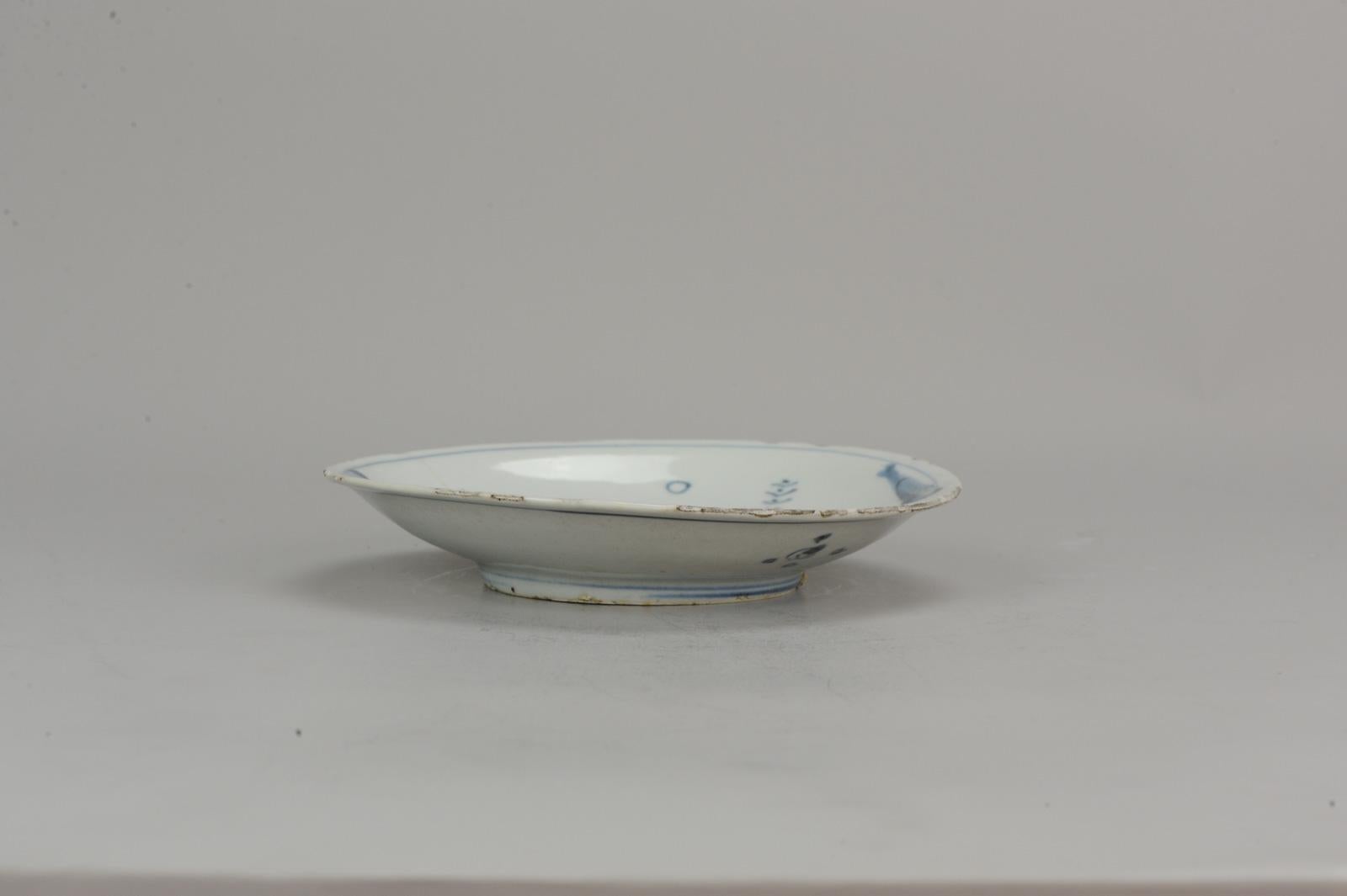 A very nicely decorated plate with a rare version of a scene of a scholar and attendant reaching a city.

Reference;
Trade Taste and Transformation: Jingdezhen Porcelain for Japan, 1620 - 1645 by Julia B. Curtis, page 95
