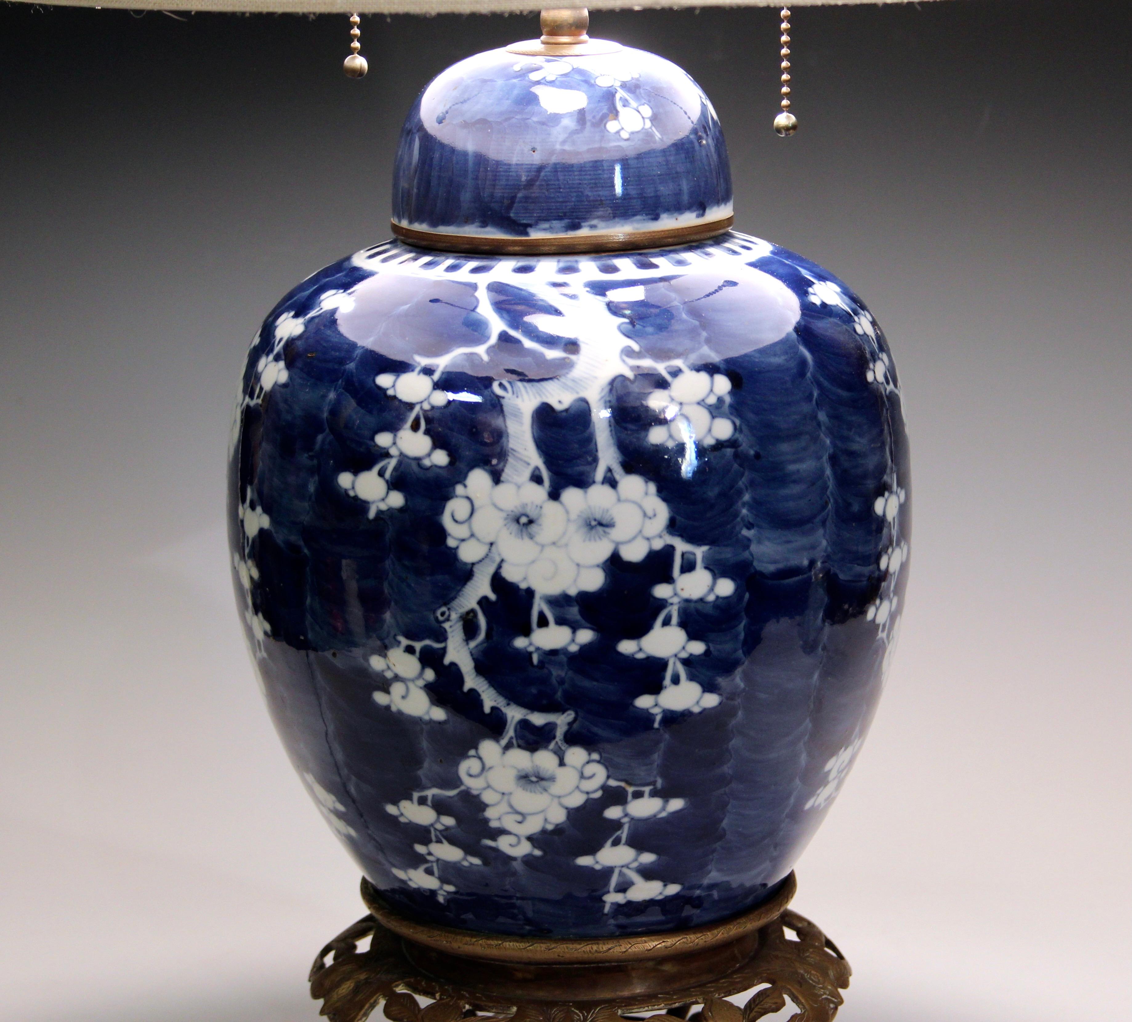 Antique Chinese porcelain blue and white Hawthorn pattern ginger jar lamp. With original cover. China stamp, circa 1910. Nice old brass hardware with adjustable double S sockets, smooth pulls, shade riser, etc. New wiring. 28