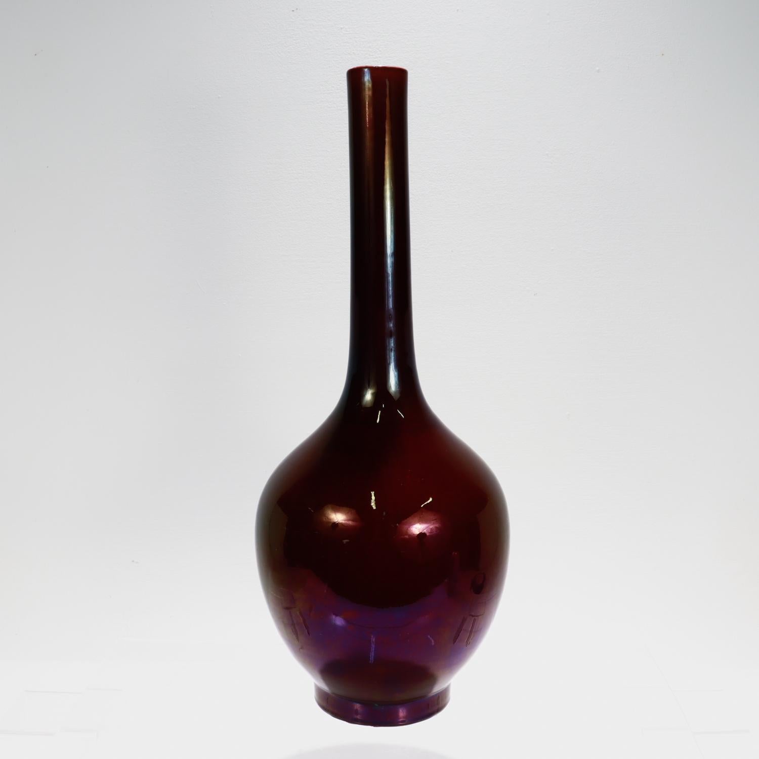 A fine antique Chinese porcelain vase.

In a mallet or handbell shaped form (摇铃尊, yaolingzun) and decorated with a lovely aubergine or eggplant colored glaze throughout.

The glaze thins and becomes a bit lighter shade as the nears the top rim.