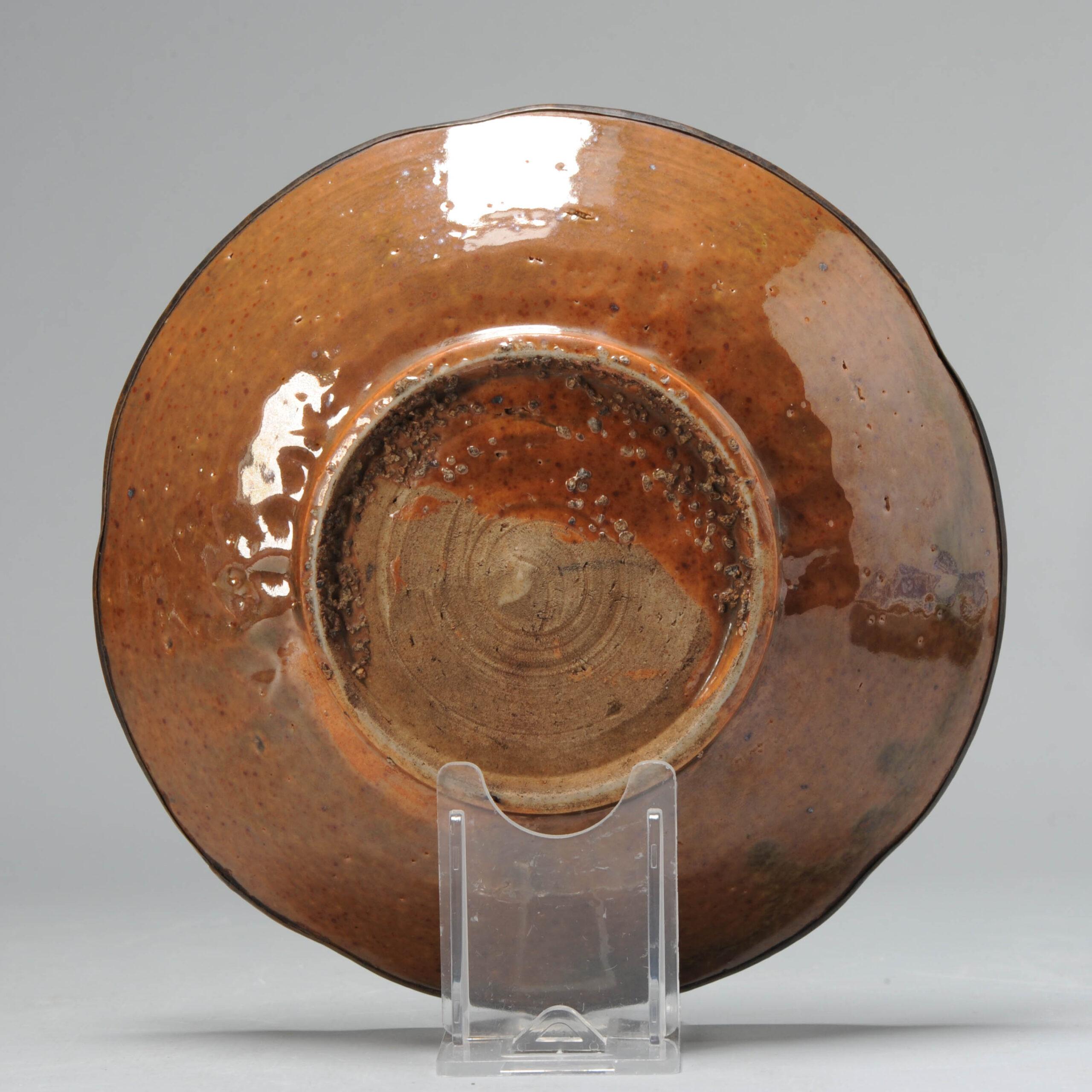 A very nicely decorated plate with beautiful Brown Glaze and an underglaze scene in white. The rim covered with a metal ring. Dated to the late Ming or transitional period.

The back without decoration but fully glazed, except for part of the