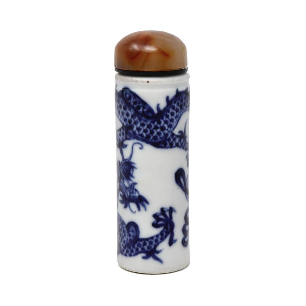 Chinese porcelain dragon snuff bottle, unusual cylindrical pillar form with no neck, unglazed top and bottom concentric grooved base, narrow aperture, painted in under glaze cobalt blue of a single five clawed dragon wrapped around the body chasing