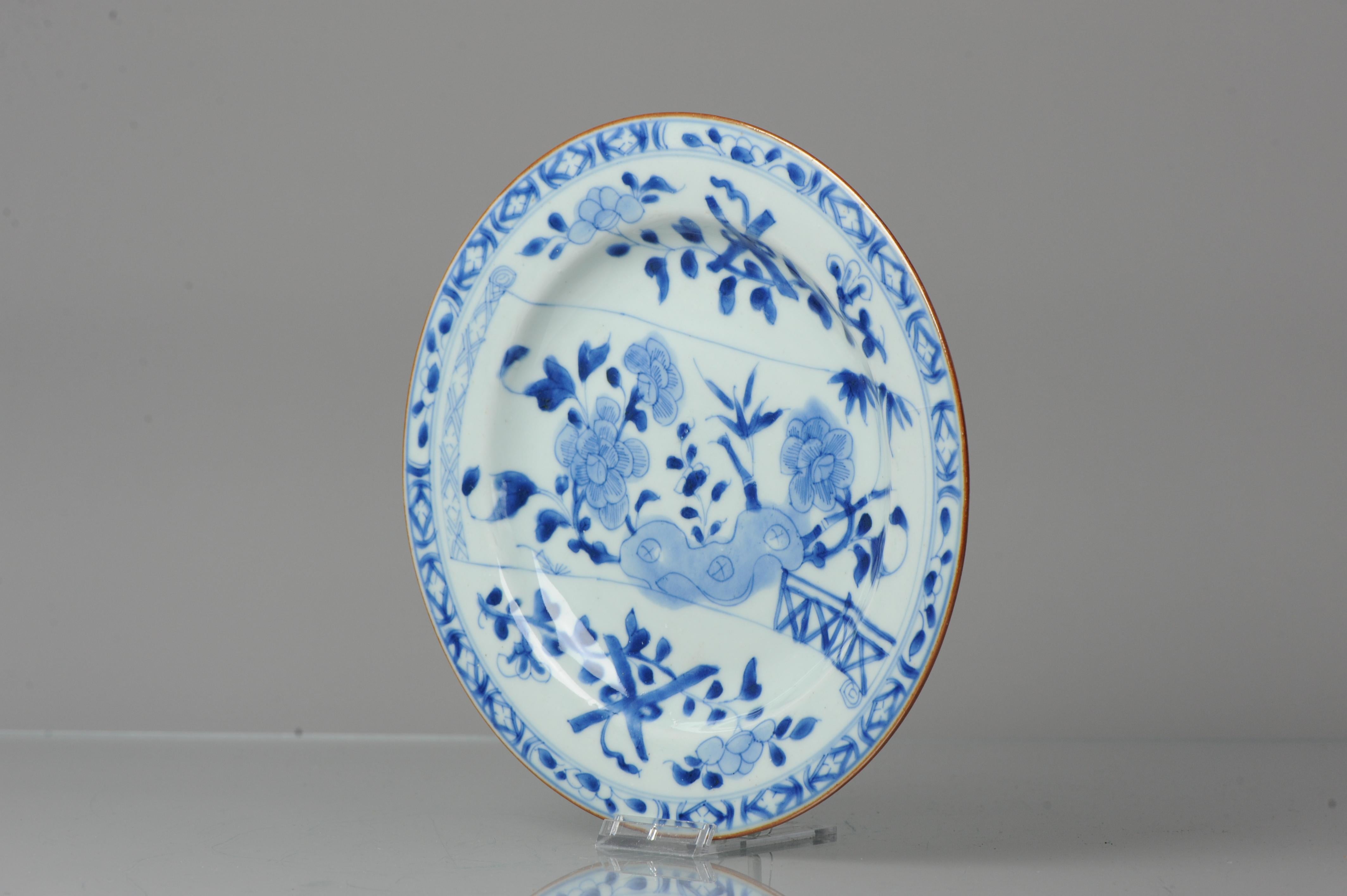 Kangxi period 18th century chinese porcelain scroll dish. Visible is a garden scene painted on a scroll. Three friends of winter, fences and objects are painted in different kind of combinations. This is a scene to get lost in.

Additional