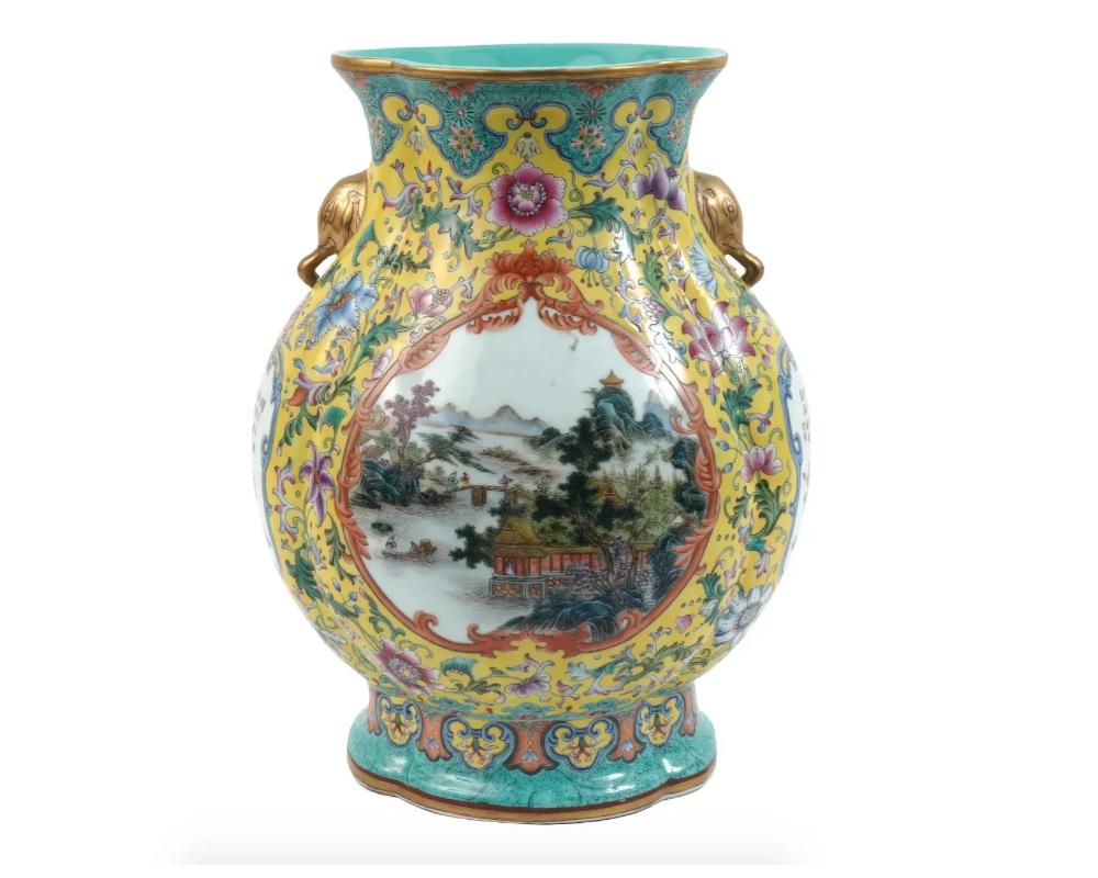 An antique Chinese porcelain vase of Hu form decorated with rich enamel colored flowers over yellow glazed ground, with elephant head handles to both sides of the neck, and a large medallion with a Famille Rose landscape over white glazed ground.