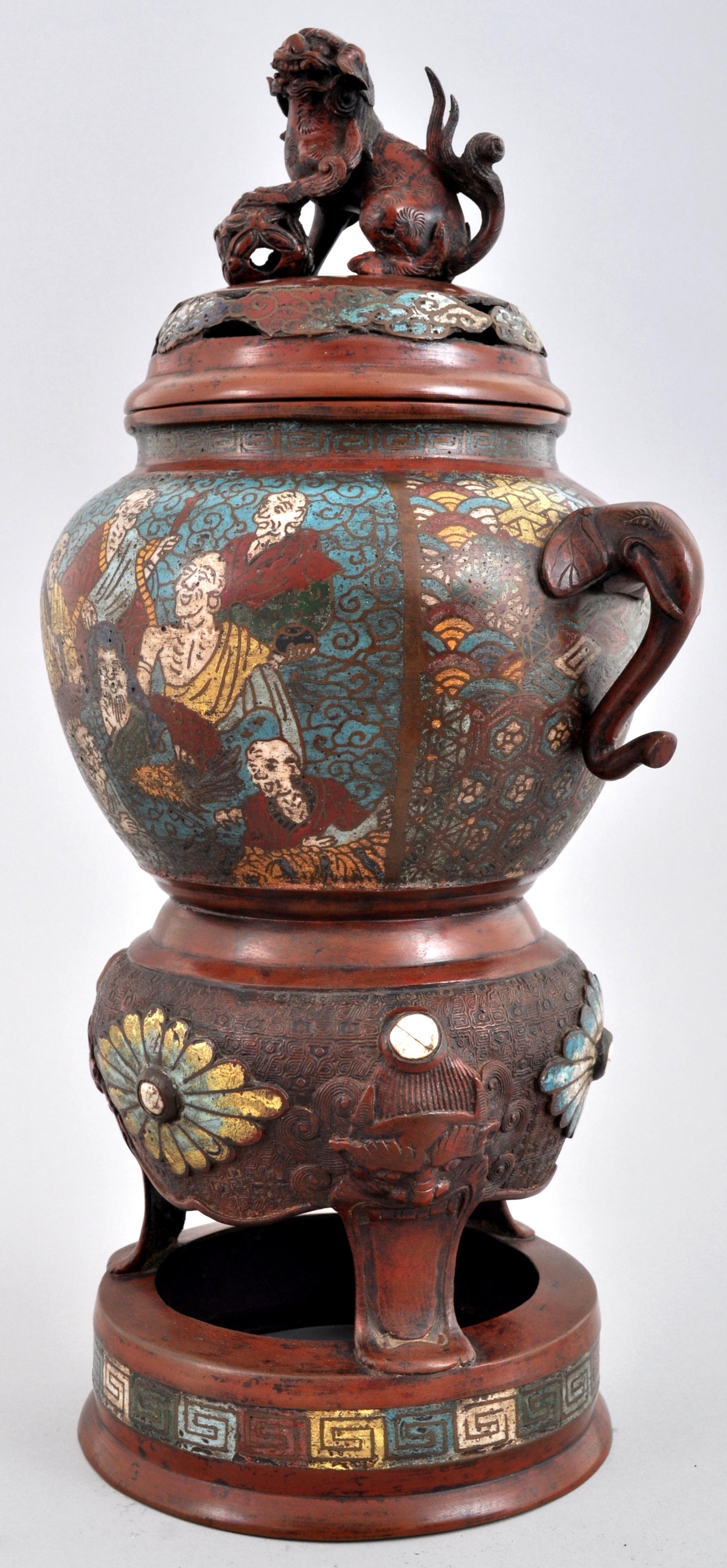 Ancien encensoir champlevé en bronze émaillé de style archaïque chinois, vers 1900. 
L'encensoir à couvercle est orné d'un fleuron en forme de chien de Foo mâle. Le dessous de l'encensoir est orné d'une décoration en émail représentant des immortels