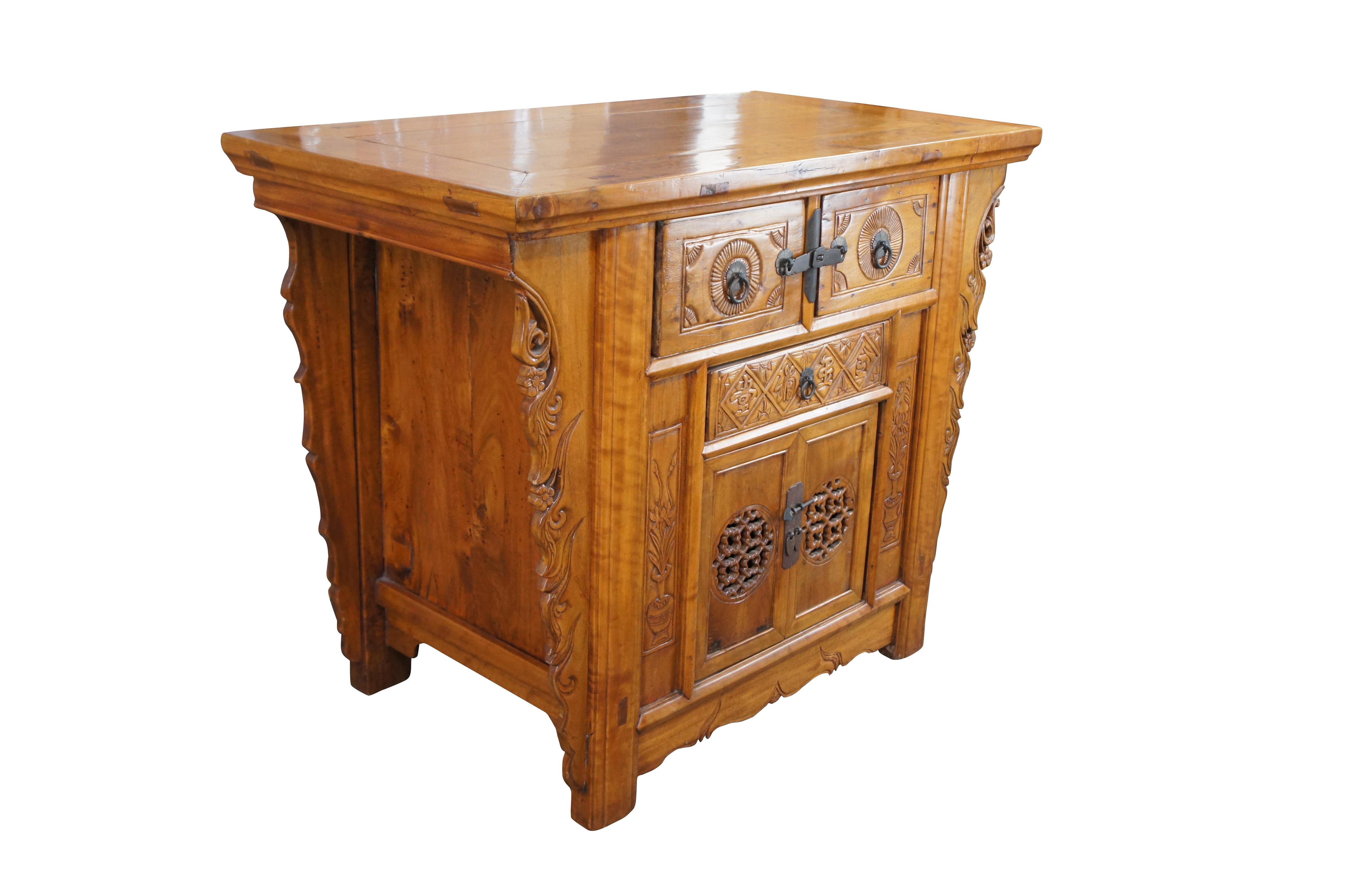 Antique Qing Dynasty altar cabinet, circa 1880s. Features a rectangular form made from elm via mortise and tenon construction. The front is carved with pierced foliate, fretwork, calligraphy and urns. Includes three dovetails drawers and a lower